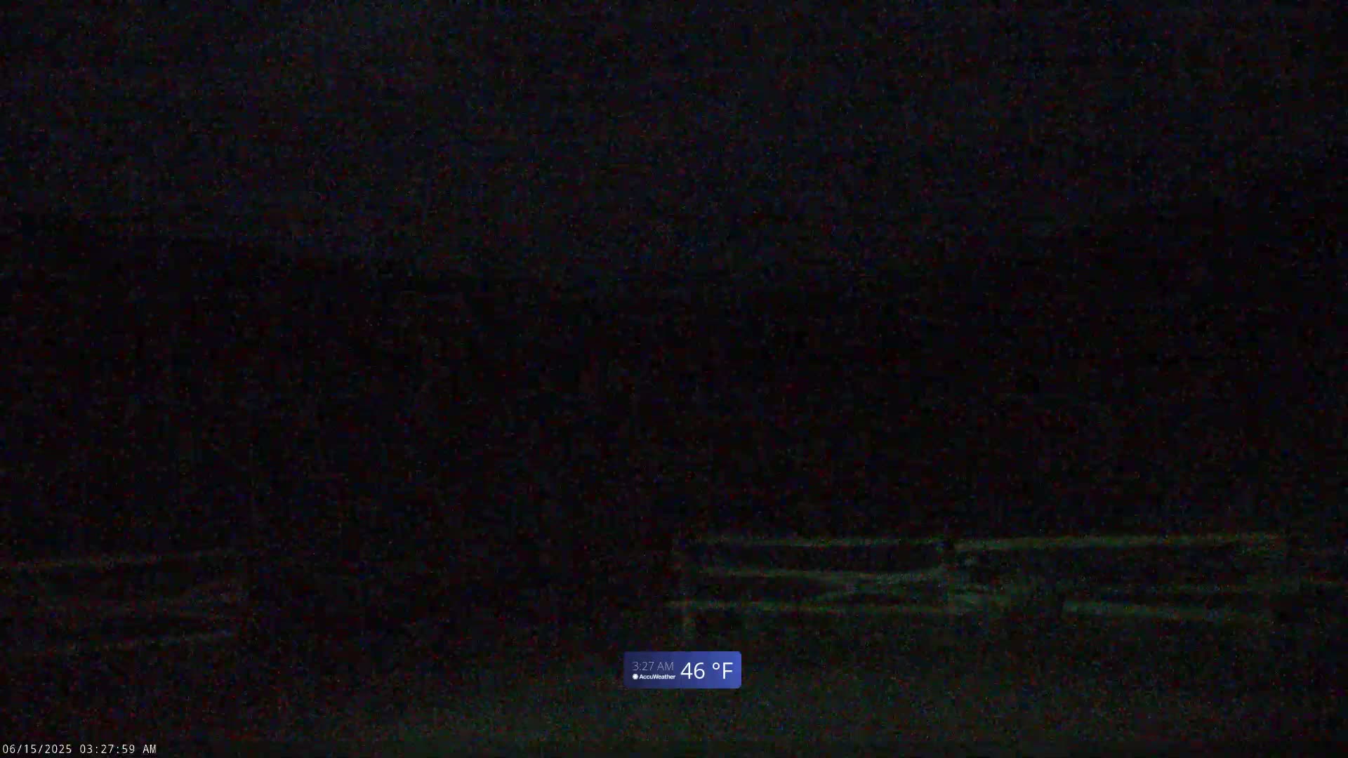 A dark nighttime scene shows a dimly lit road with faint horizontal lines, the temperature is 46°F.