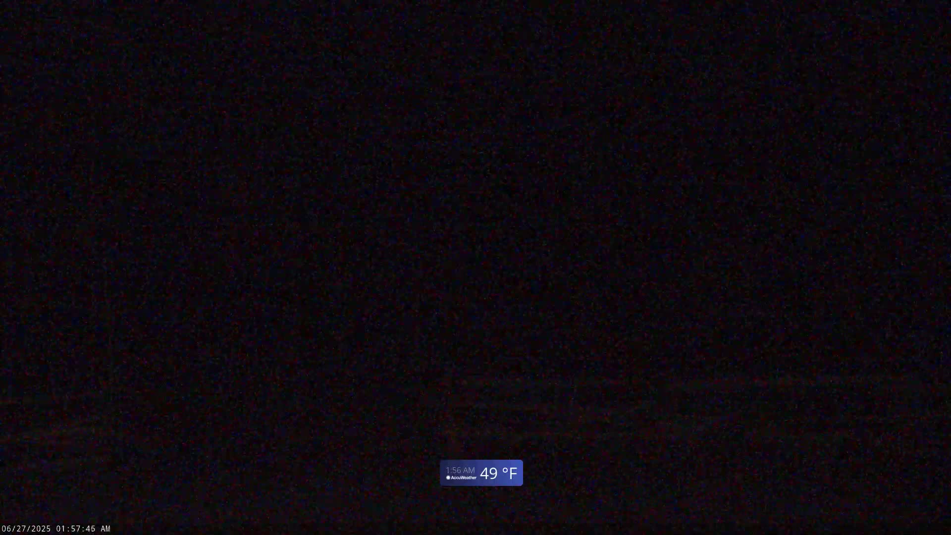 A dark, possibly nighttime image shows a mostly black scene with a hint of lighter gray at the bottom, and a temperature of 49°F is displayed.