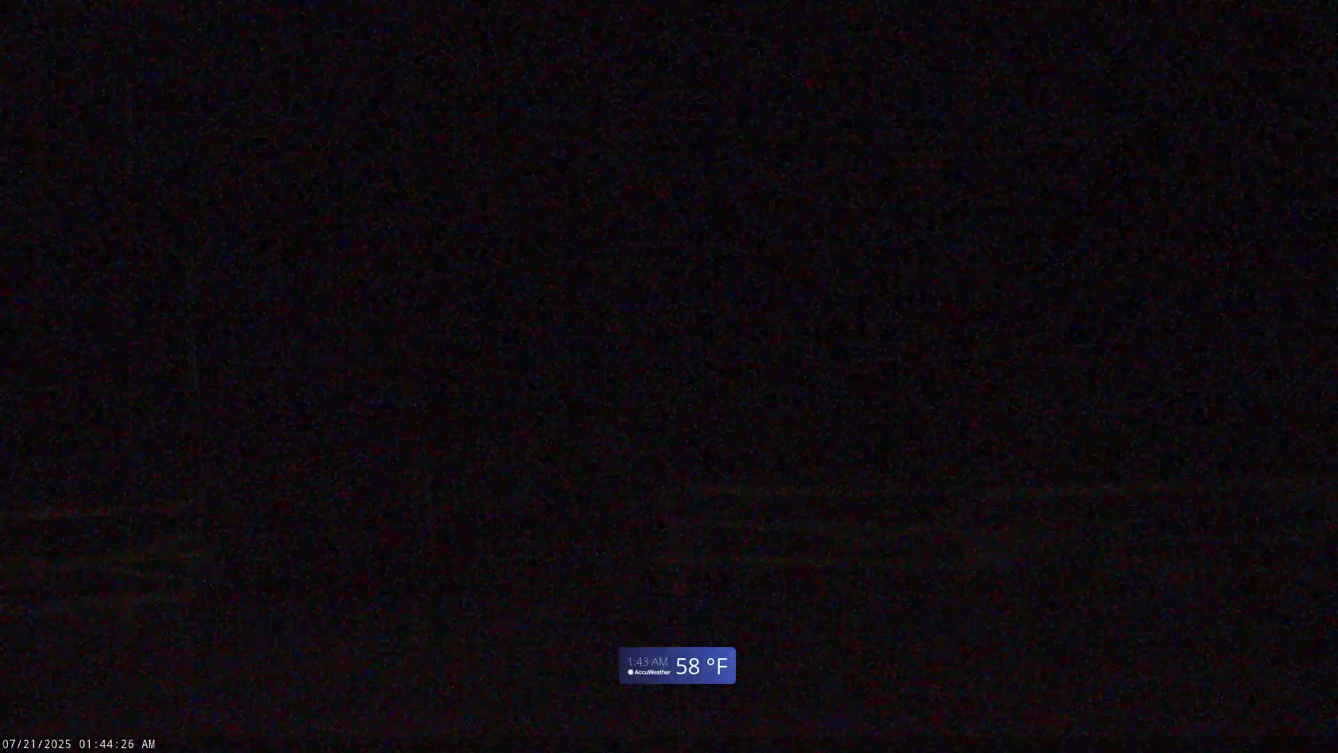 A mostly dark image shows a very faint, blurry view of a dark, possibly nighttime scene at 58°F.