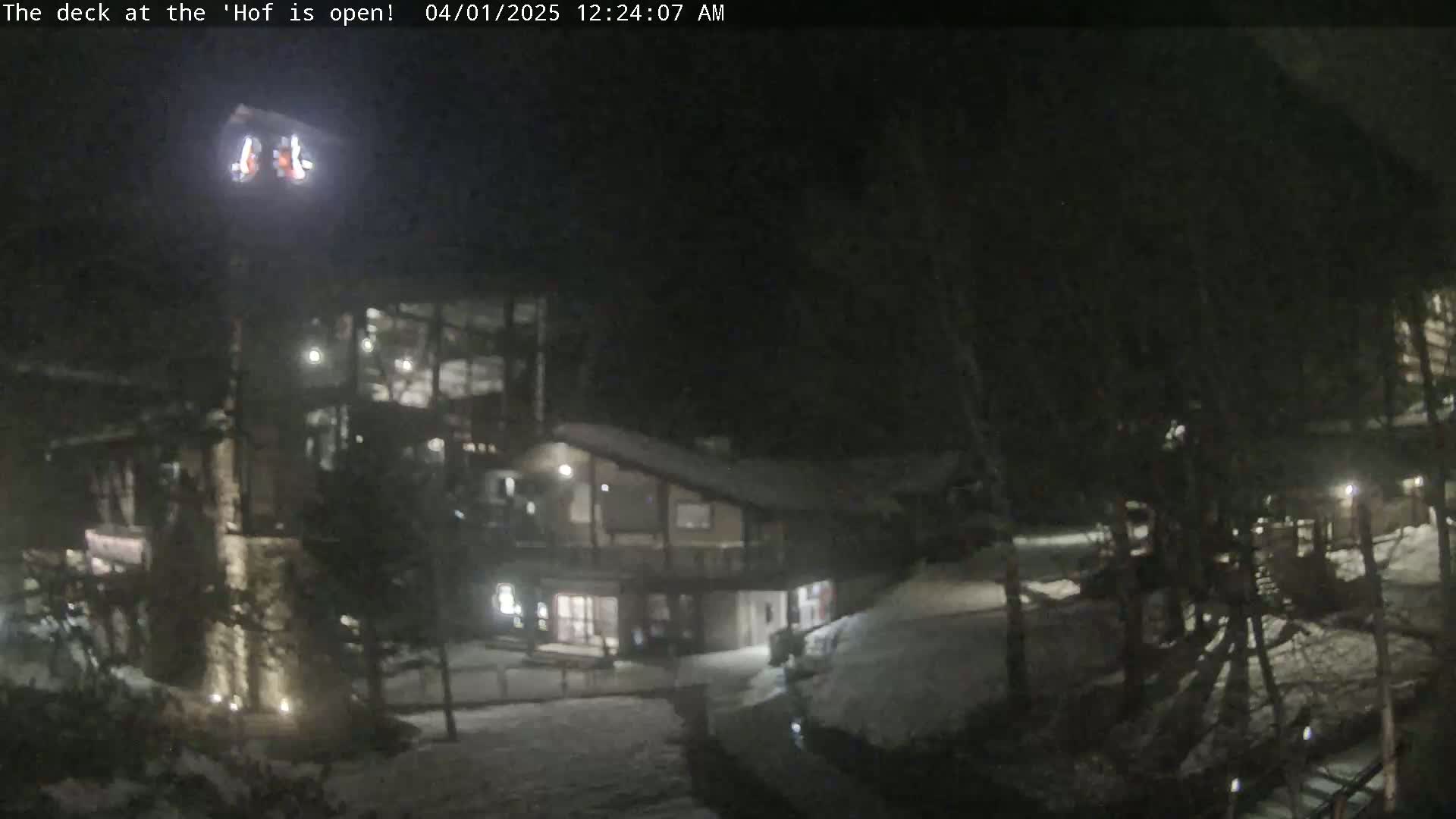 A nighttime view of a snow-covered building complex, illuminated by exterior lights.