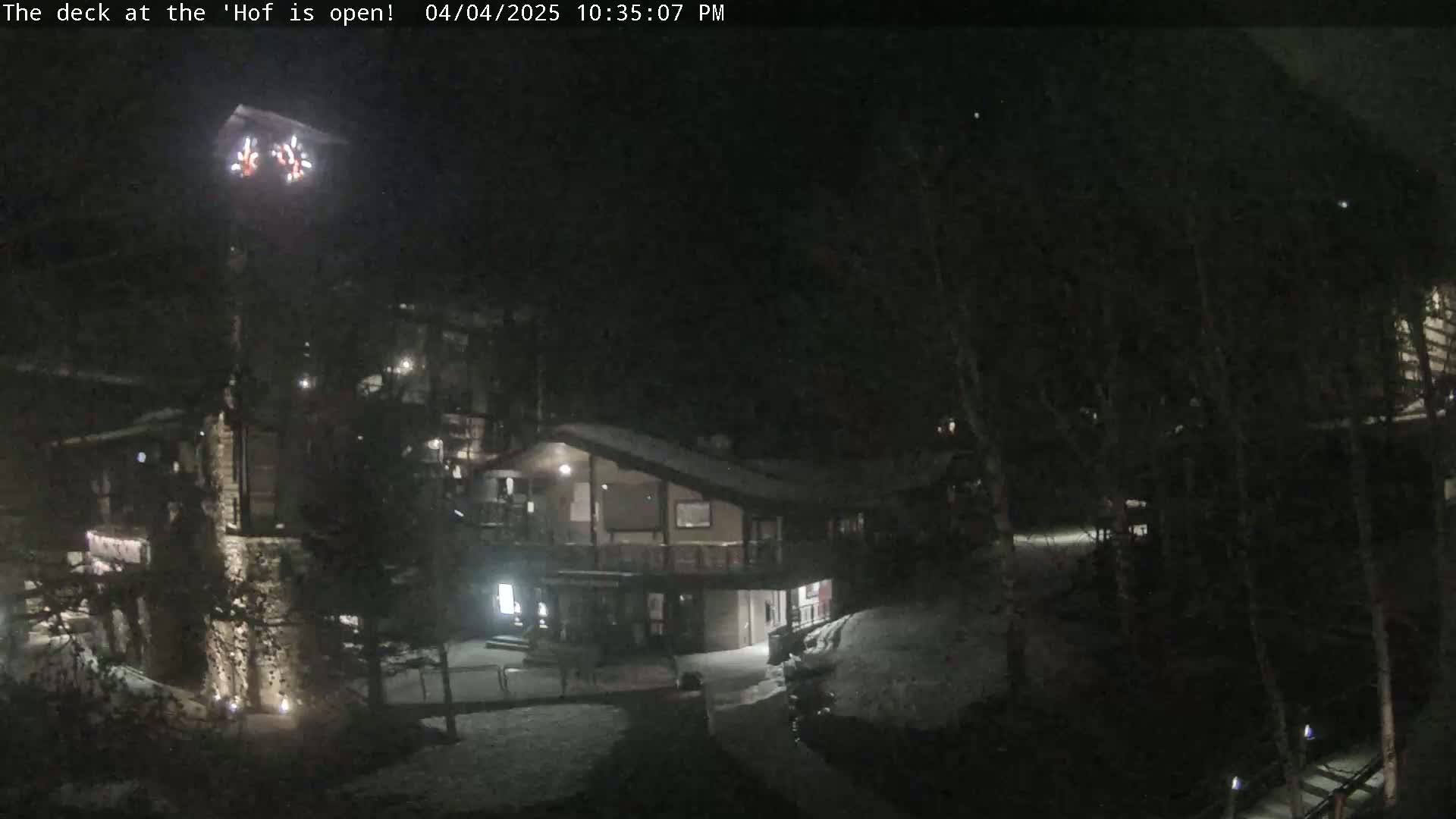 A nighttime view of a snow-covered building complex with fireworks visible in the sky.