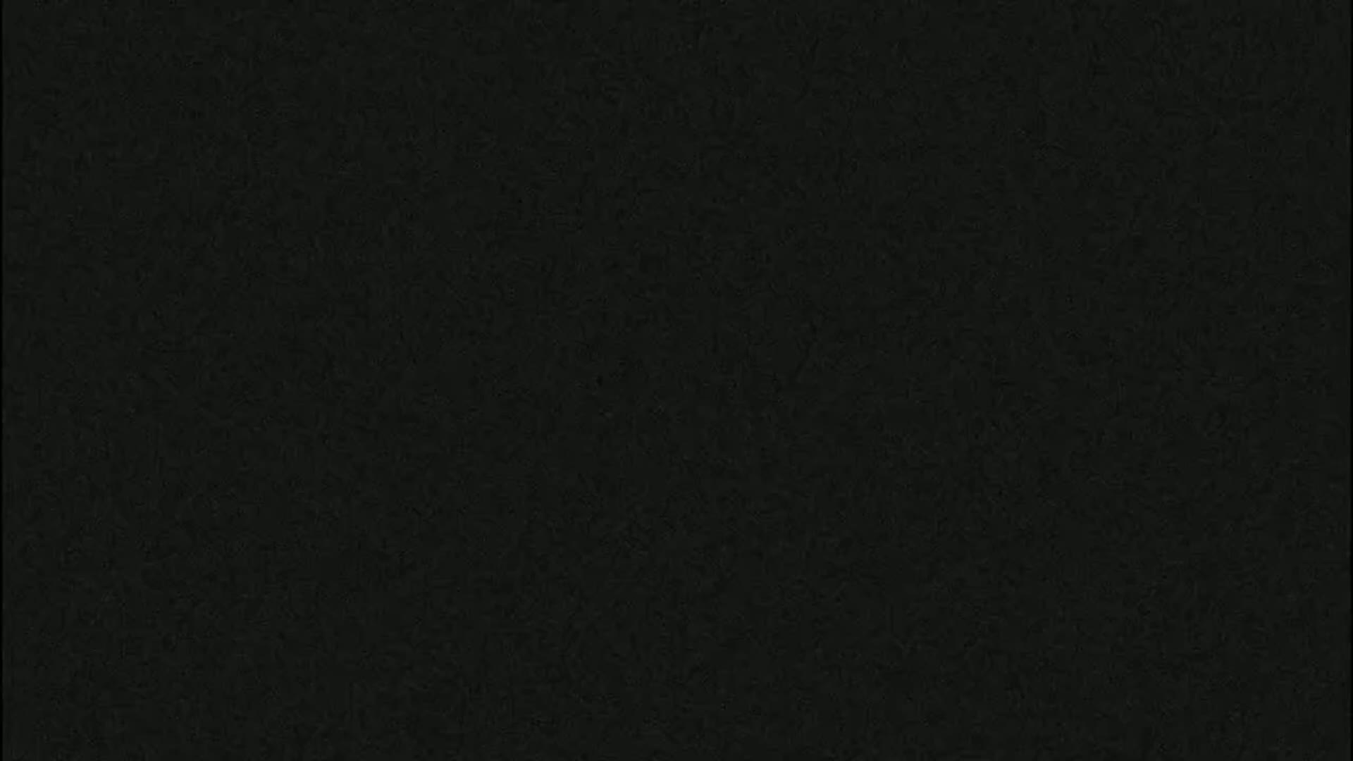 The image shows a dark gray or black textured surface.