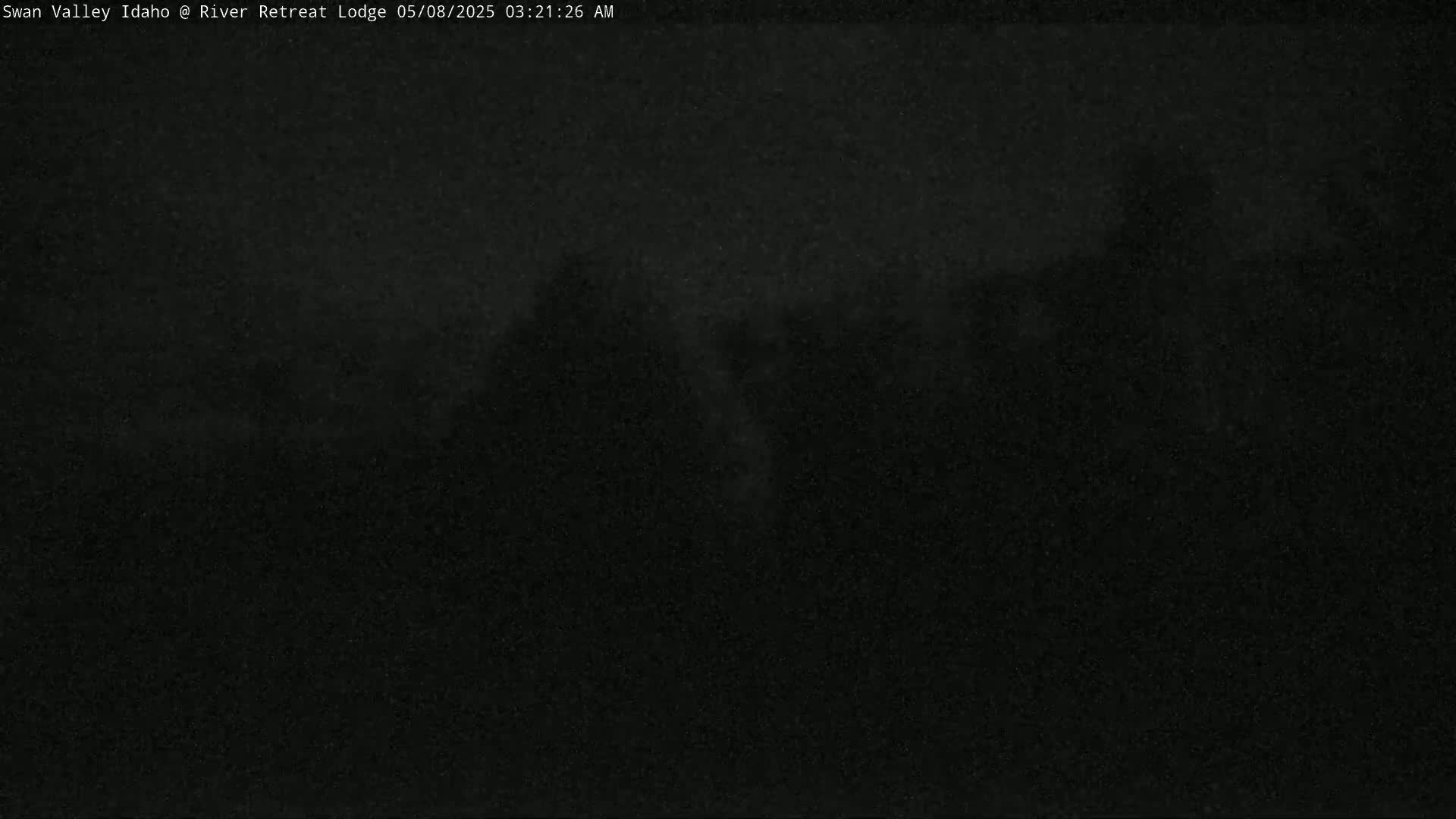 A very dark, nighttime image shows an indistinguishable outdoor scene.