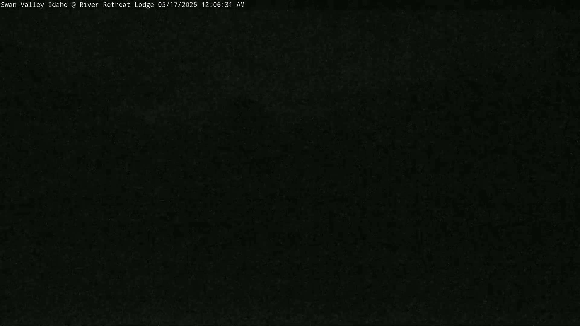 The image is a completely dark, grainy black screen.
