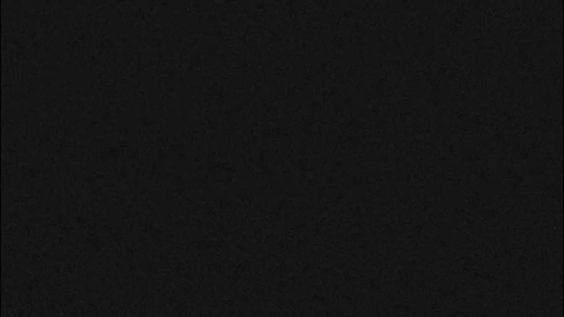 The image displays a solid black background with a subtle, fine-grained texture.