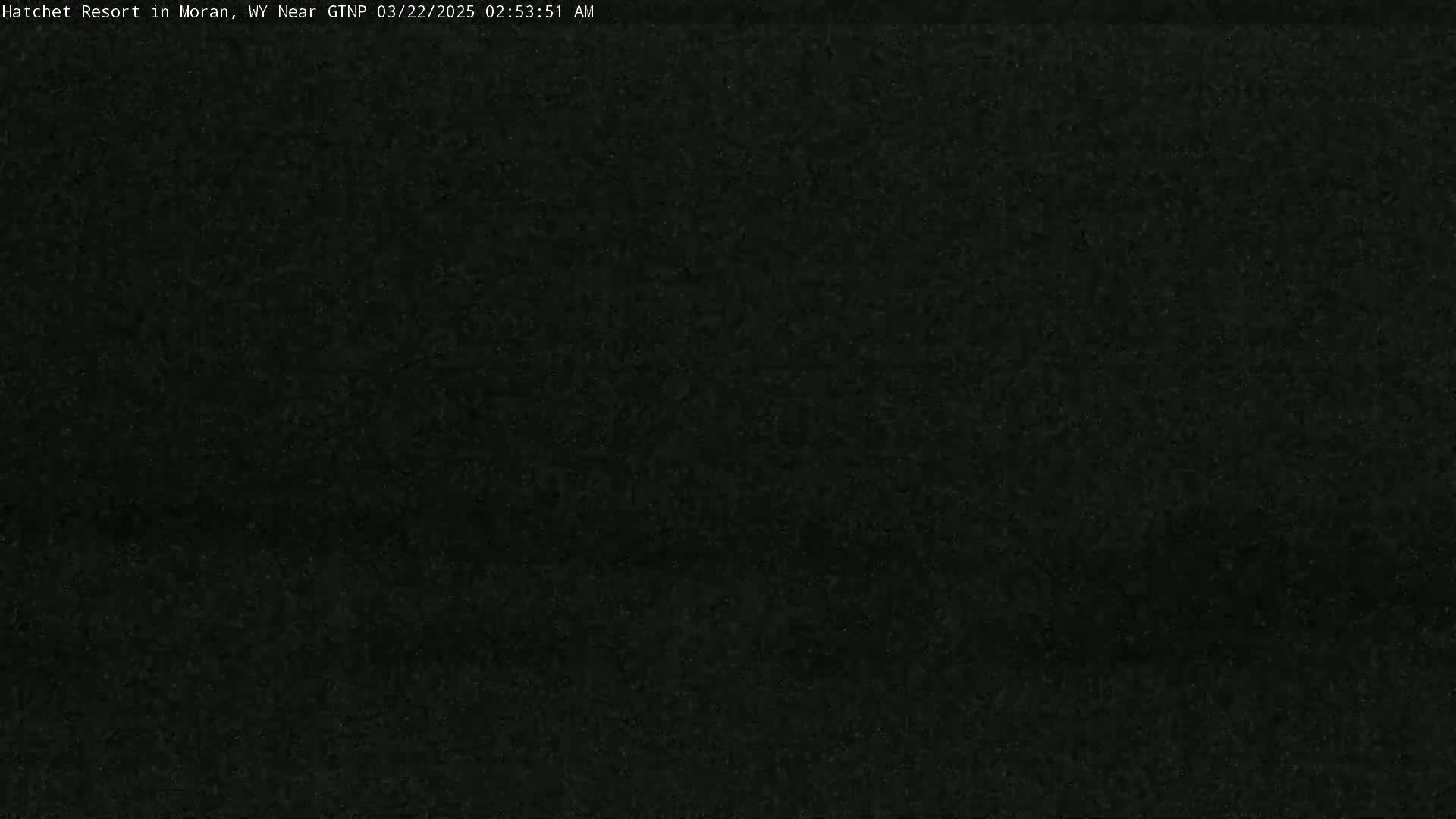 A dark, grainy image shows a completely black field of view at night.