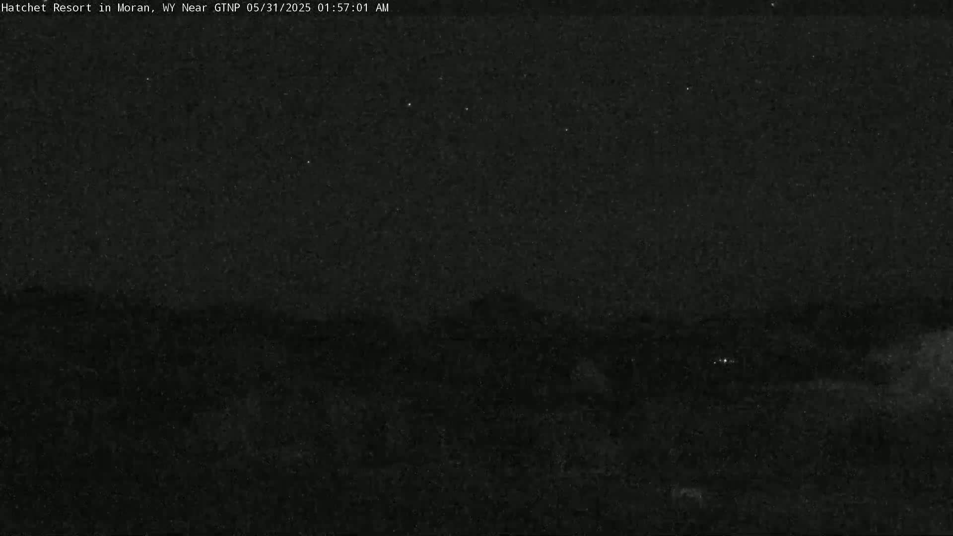 A dark, nighttime landscape is visible under a clear, starlit sky.