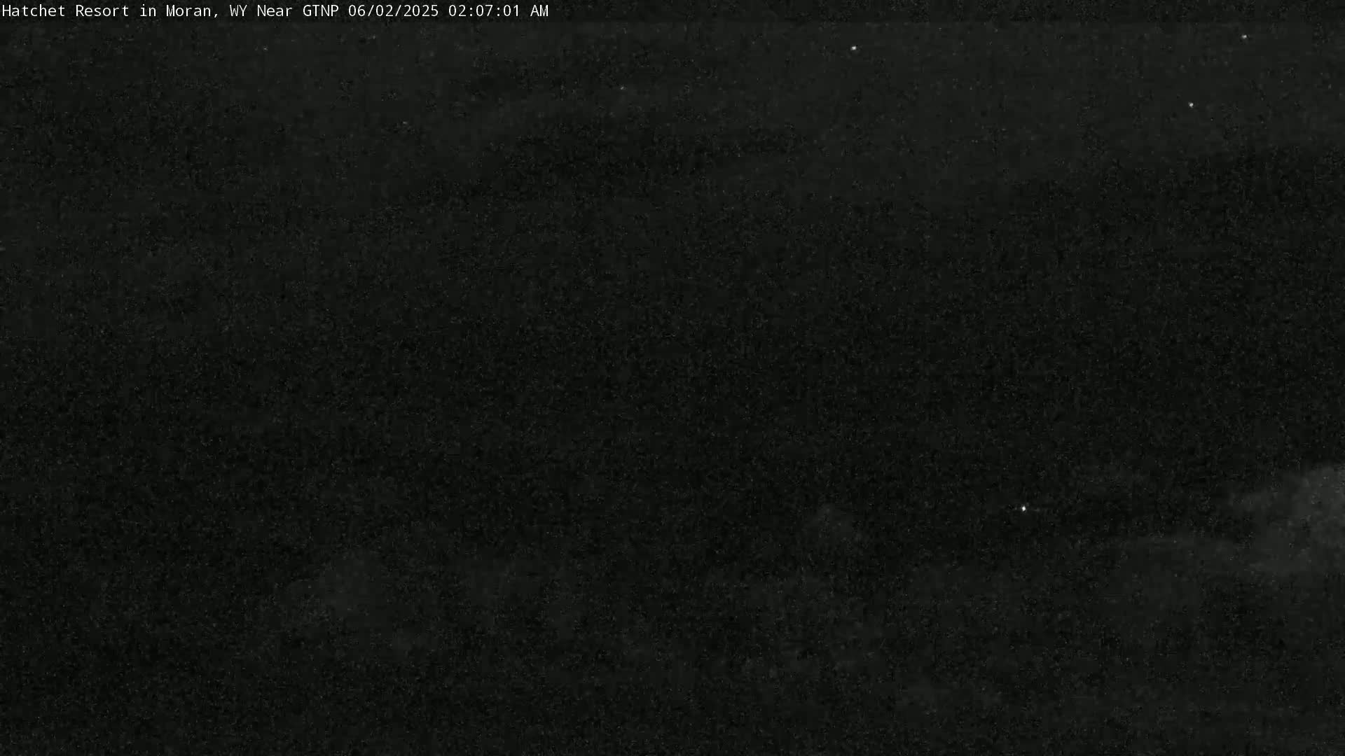A nighttime outdoor scene shows a dark sky with a few visible stars.
