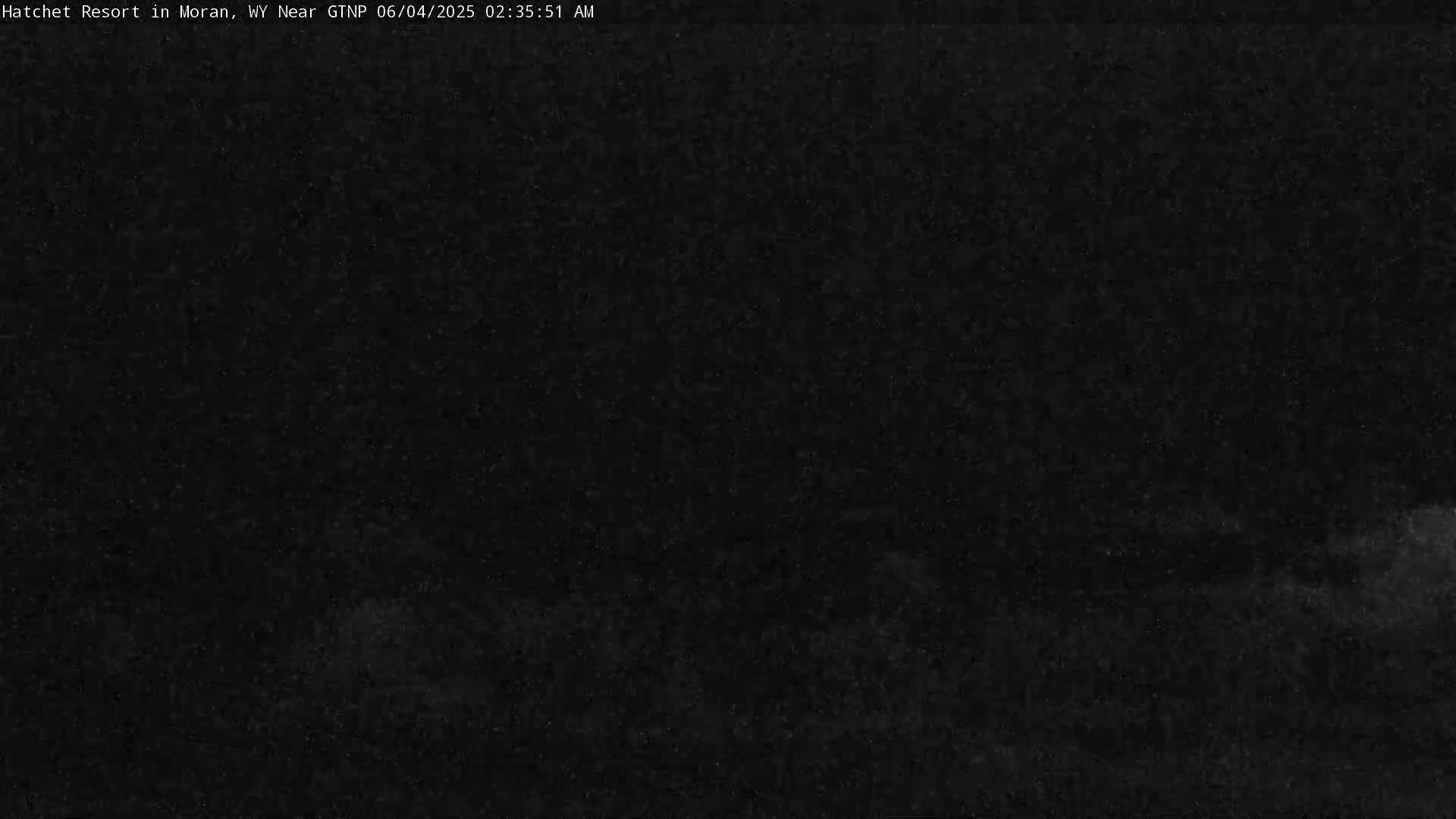 A dark, nighttime scene with a low-lying cloud cover or fog obscuring the ground.