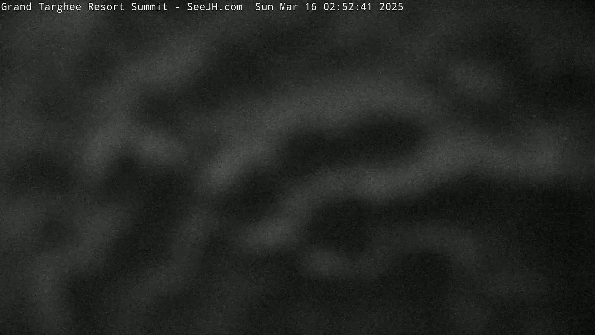 A dark, blurry image shows a nighttime, possibly snowy or overcast, scene.