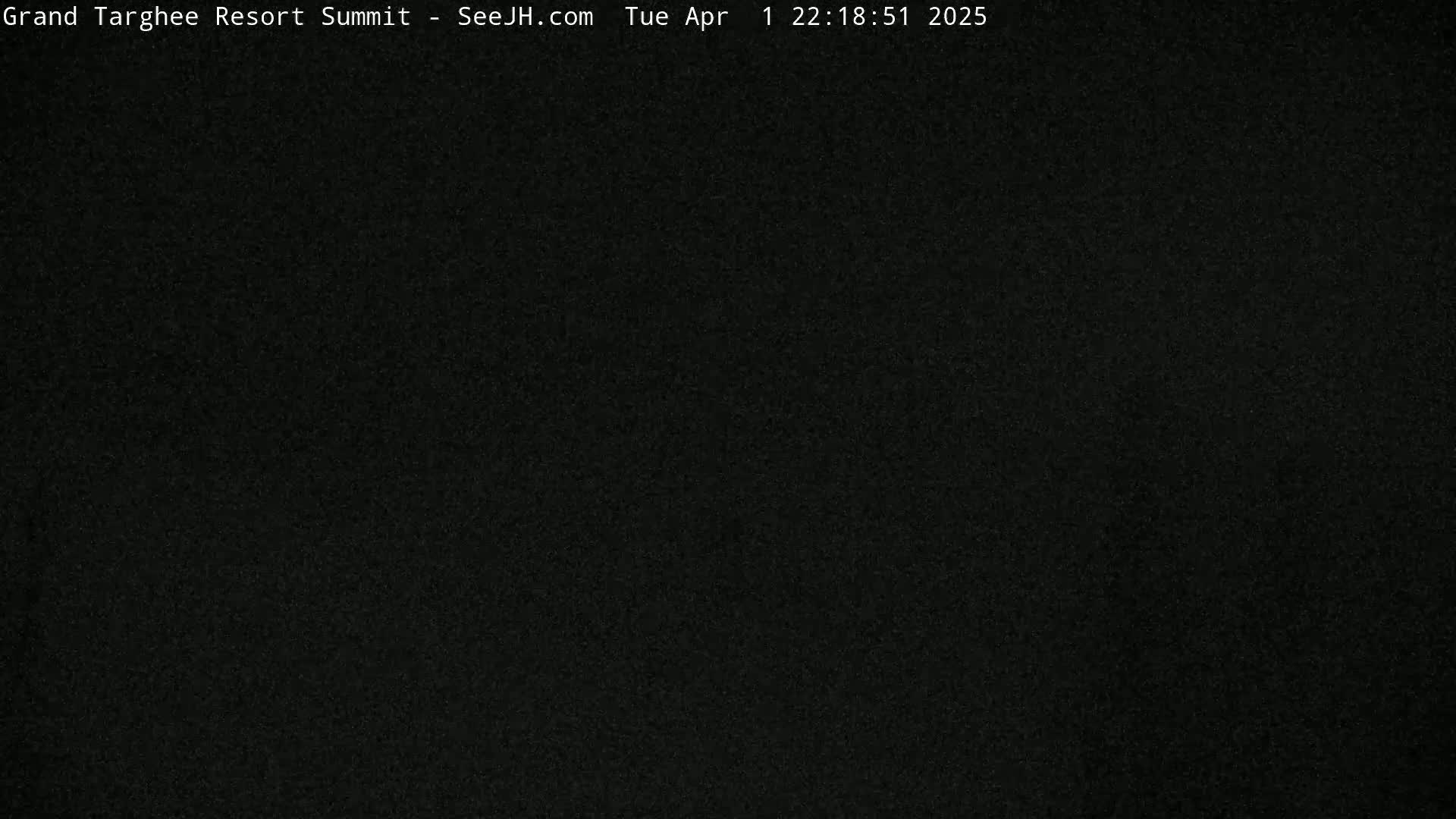 The image is a completely dark, grainy black screen.