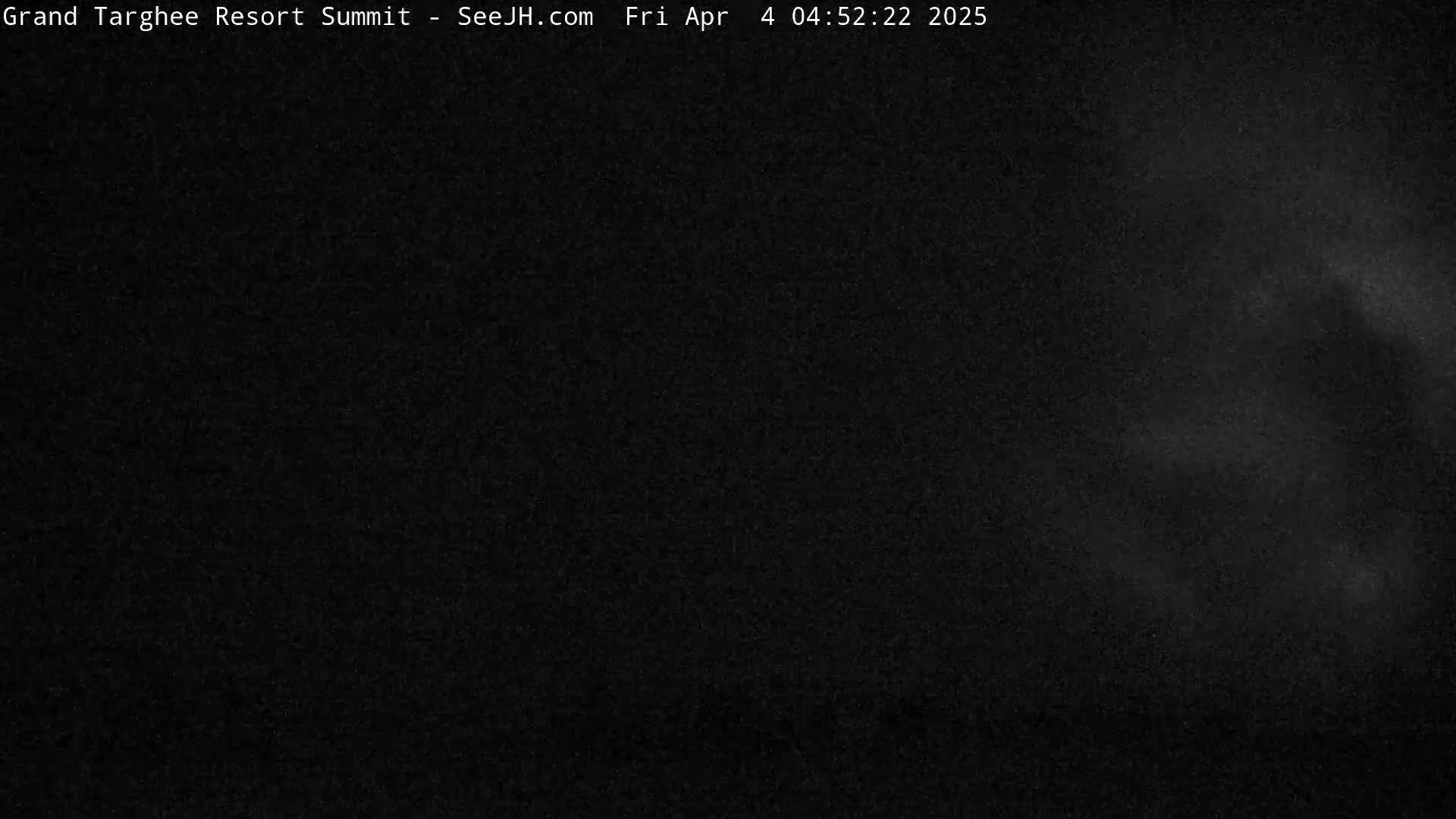 A dark, nighttime scene with a faint, hazy glow in the upper right corner.