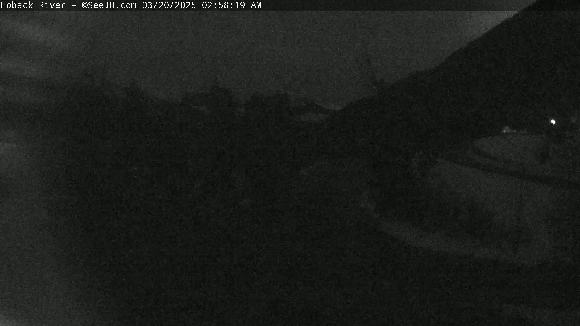 A nighttime, low-light view of a dark landscape.