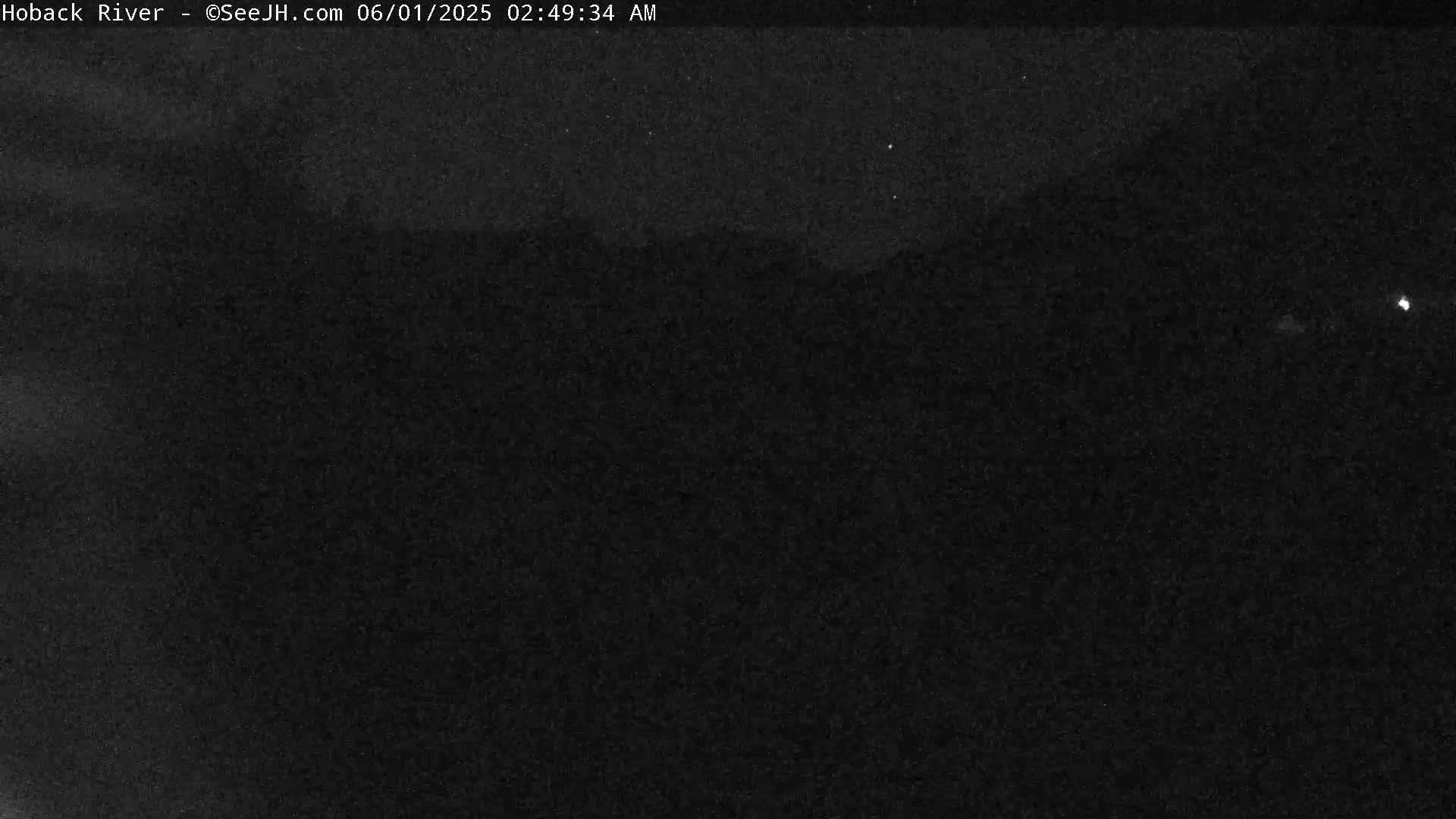 A dark, nighttime outdoor scene shows a mostly clear sky with a few faint stars.