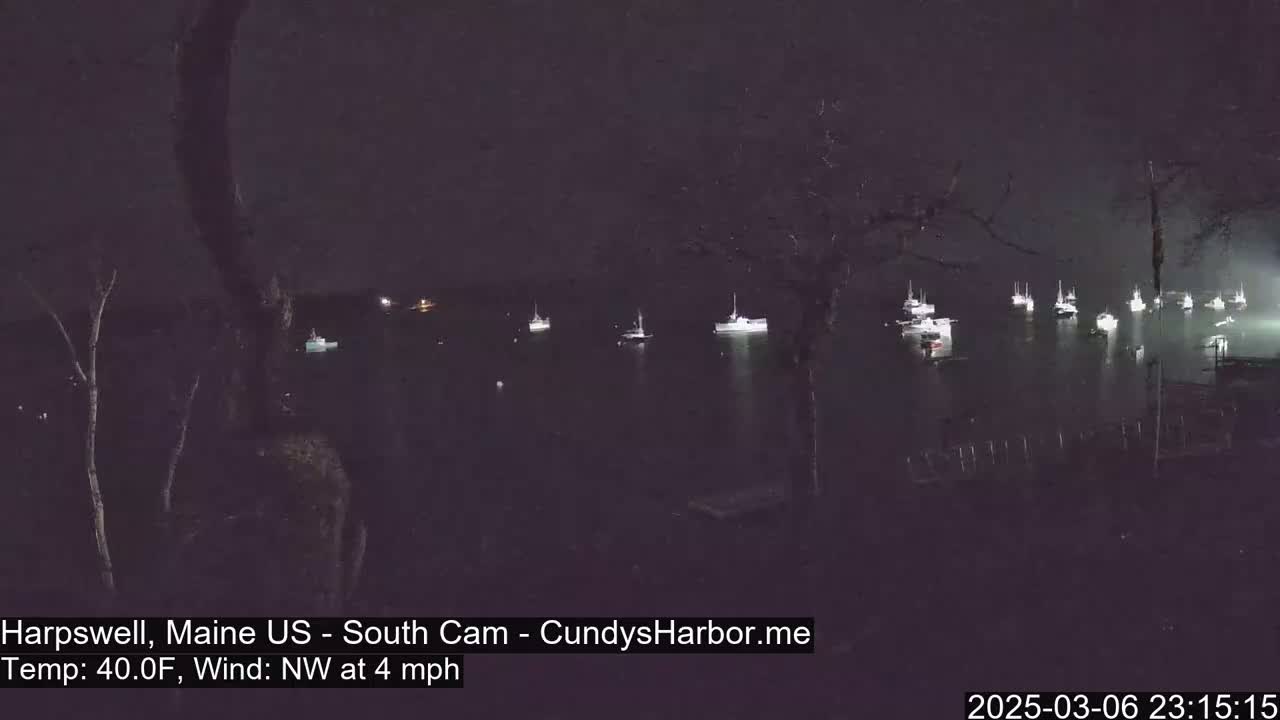 Numerous boats are moored in a dark body of water at night under a dark sky with a northwest wind at four miles per hour and a temperature of forty degrees Fahrenheit.