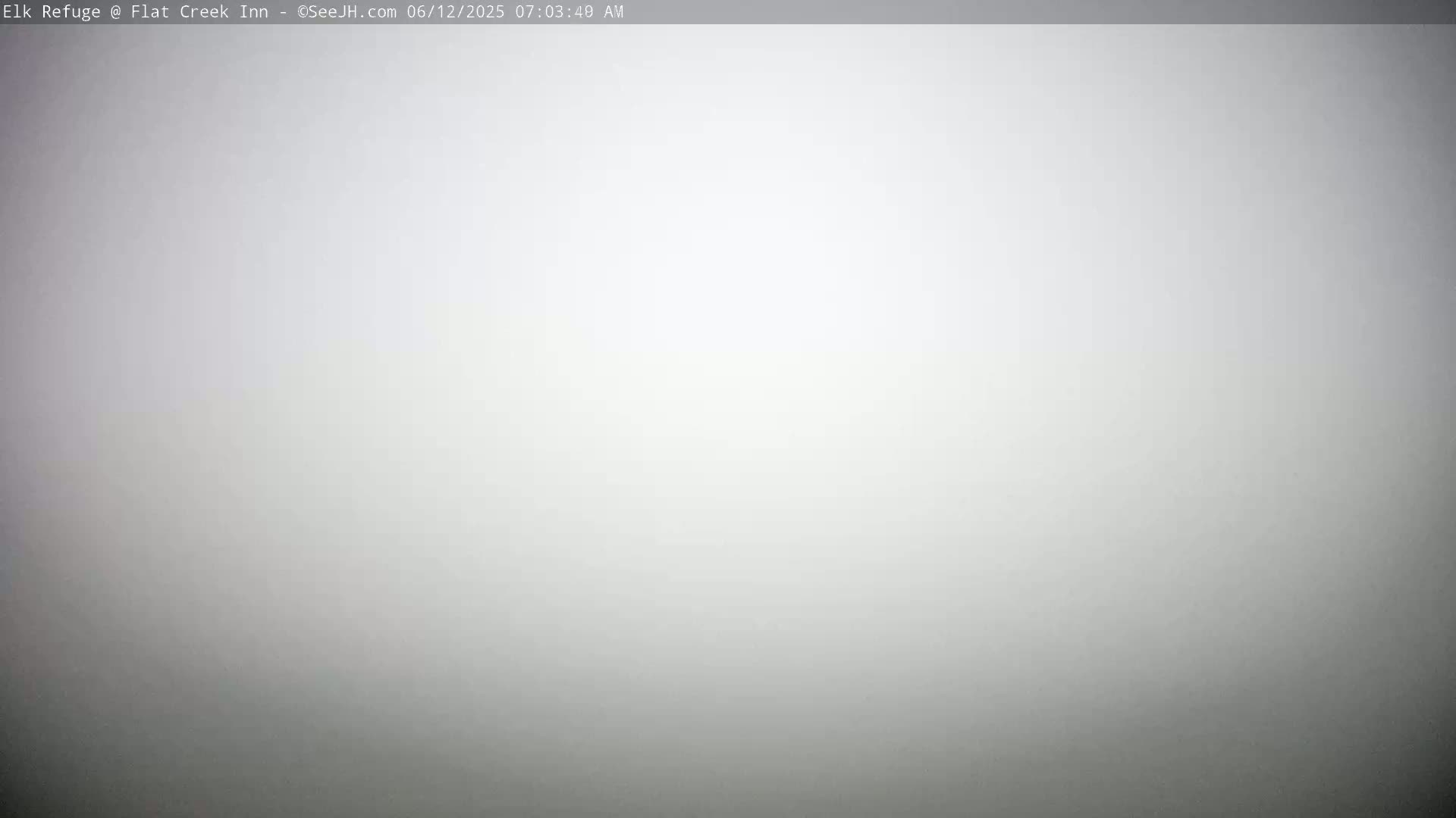 A solid, light gray image depicts a foggy or overcast sky.
