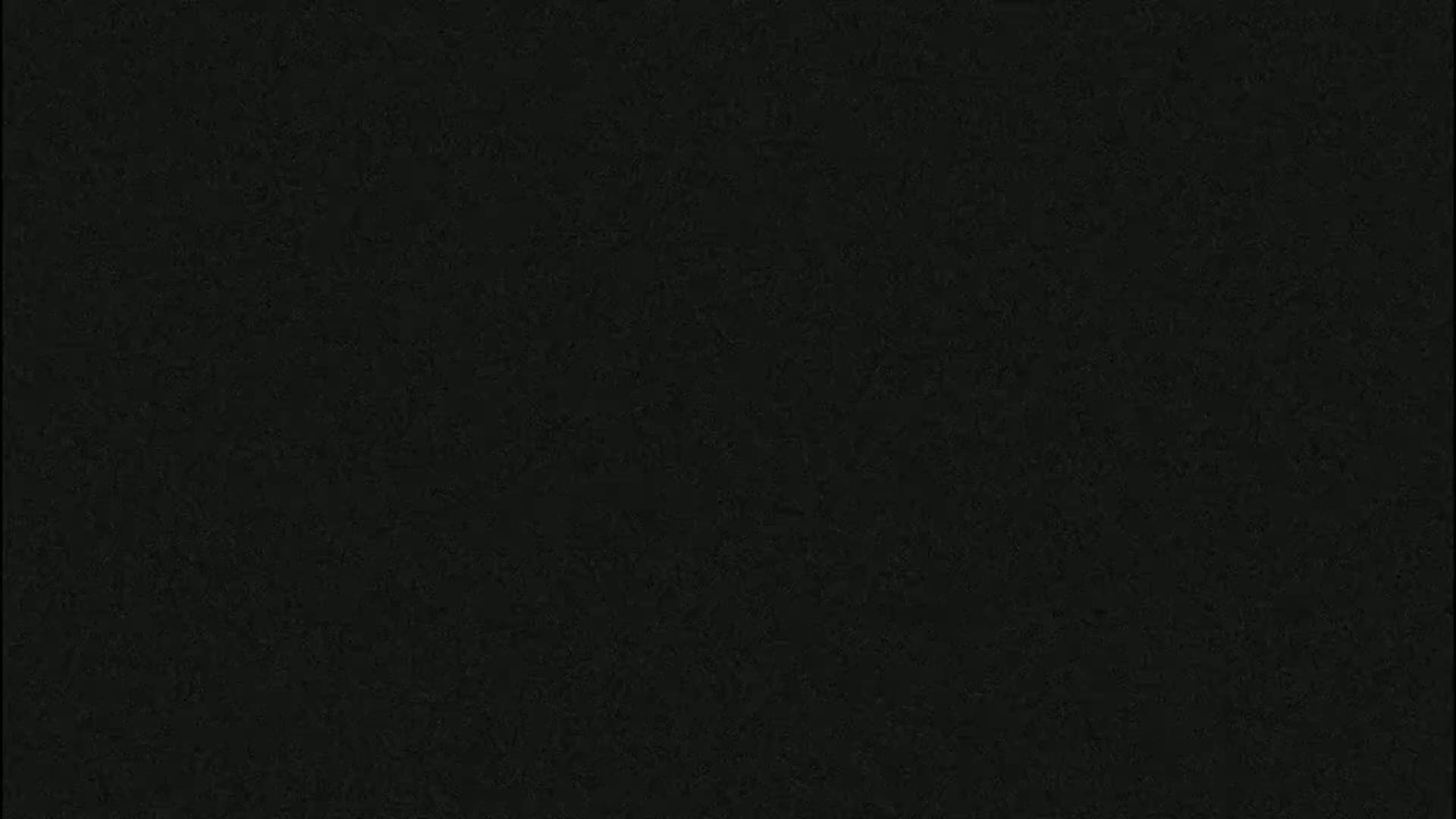 The image is a uniformly dark gray-black textured background.