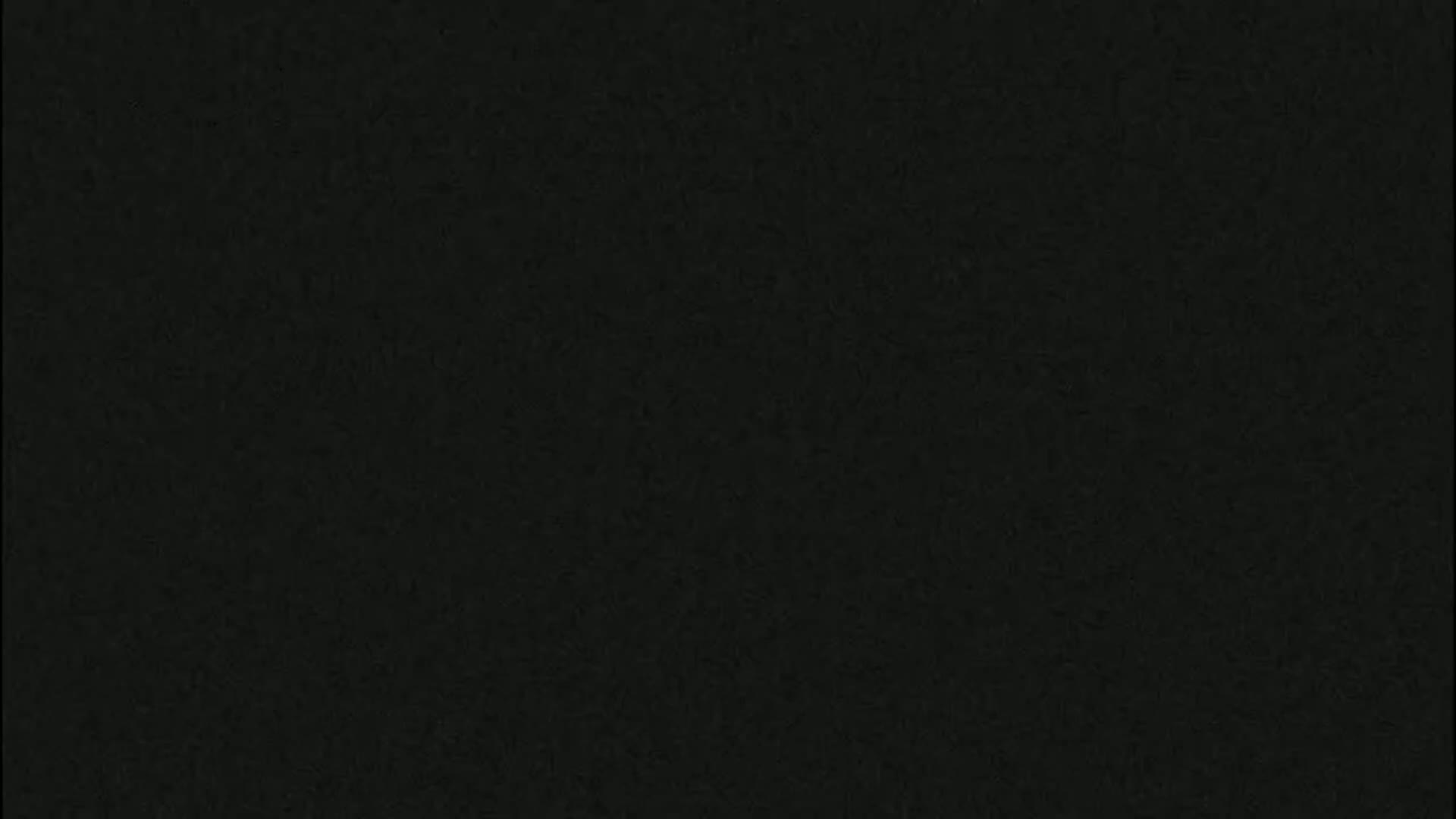 The image shows a dark gray or black textured surface.