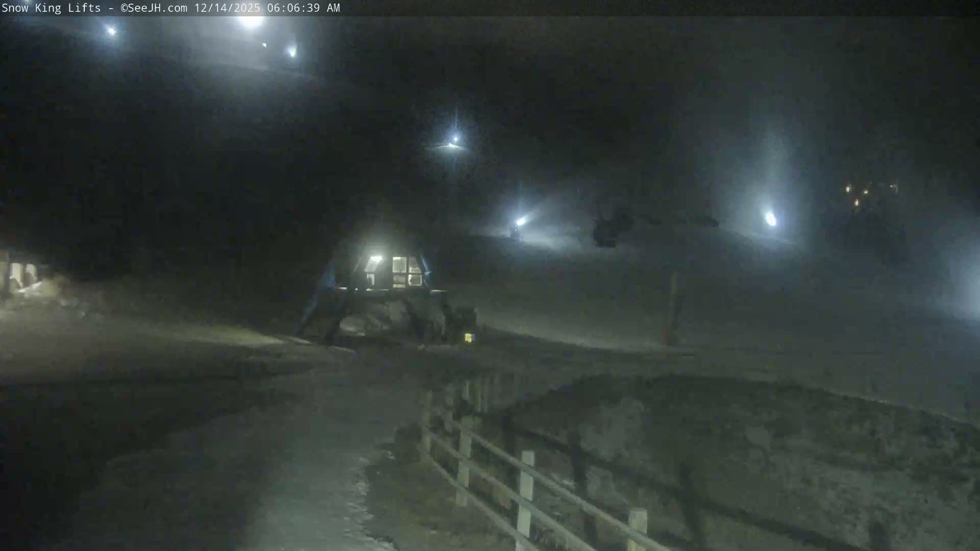 The image displays a solid black field with a very subtle, dark gray textured noise.