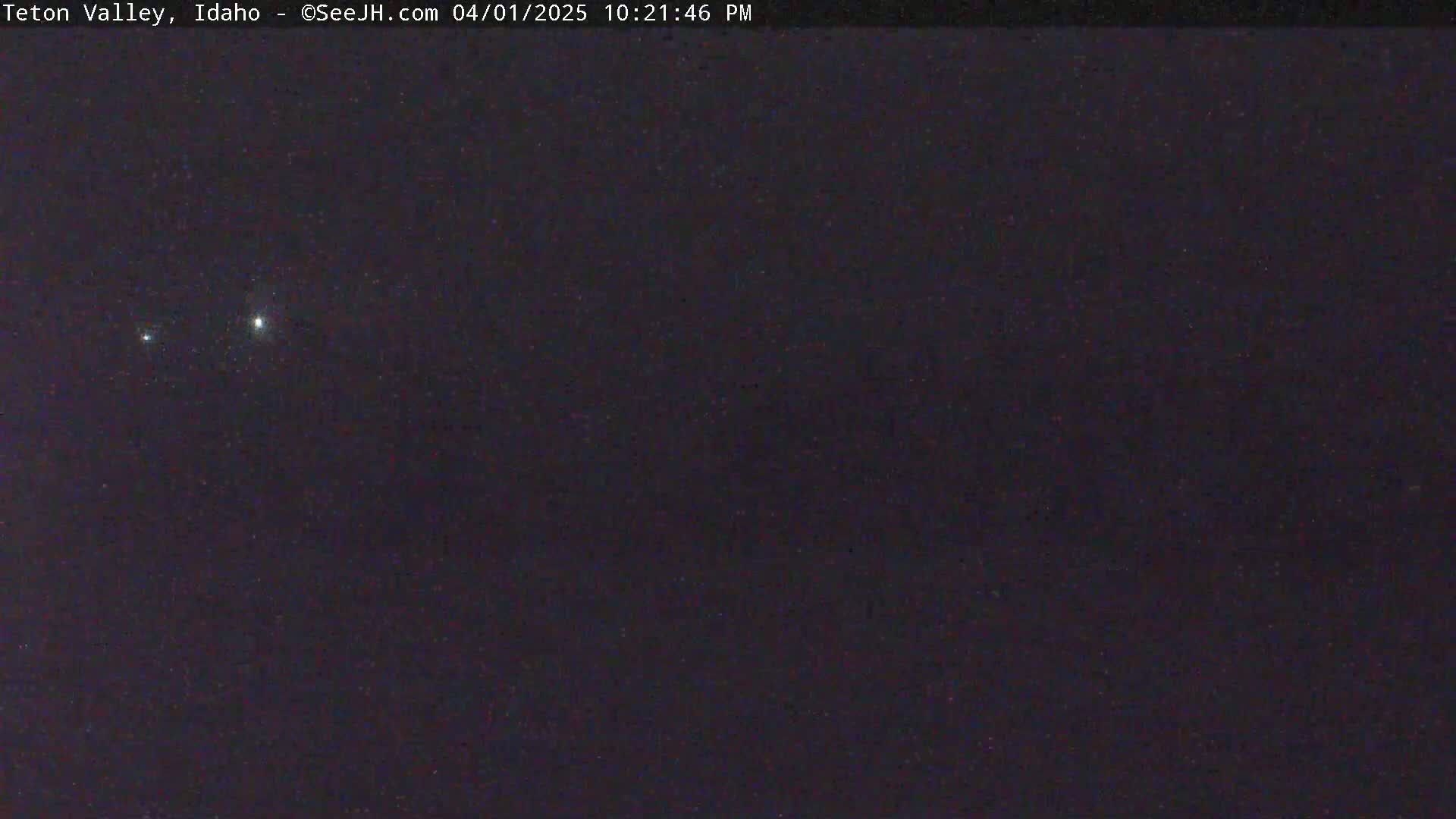 A night sky shows a few bright stars and many fainter ones.