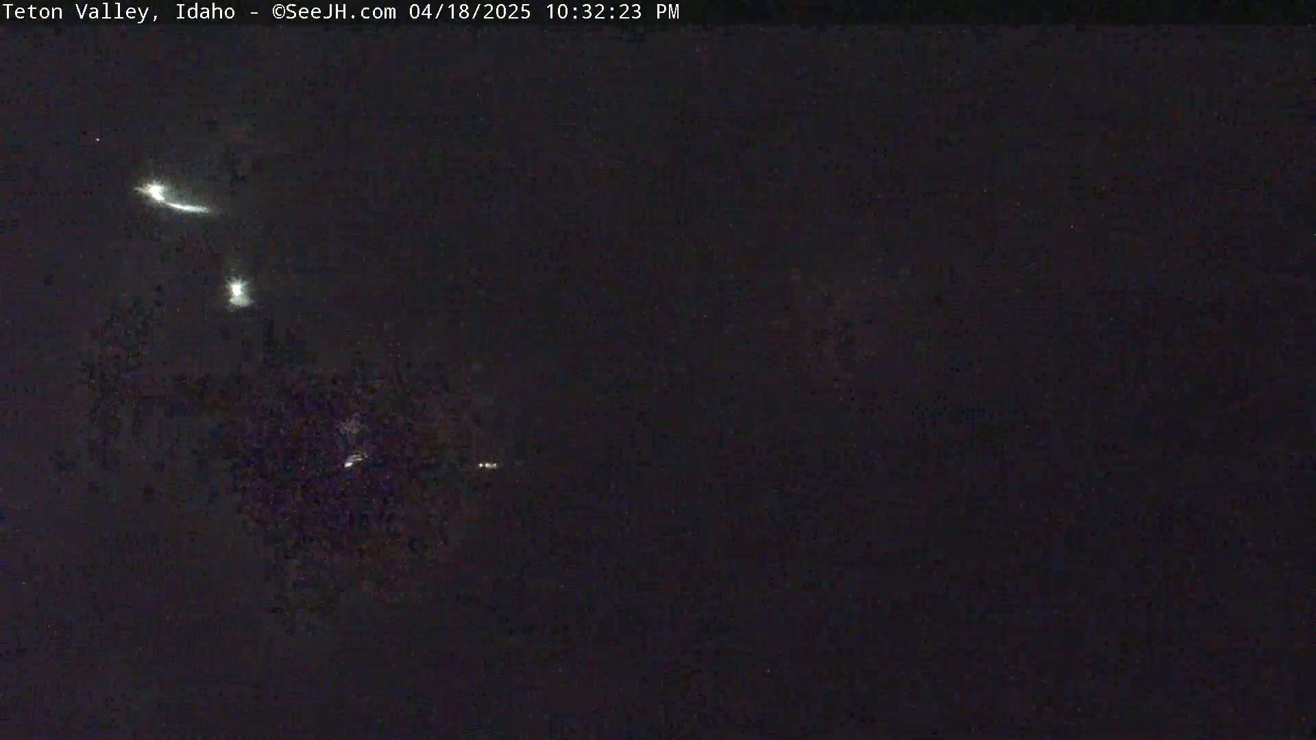 A nighttime image shows a dark sky with several bright streaks of light, possibly meteor trails, visible against the dark background.