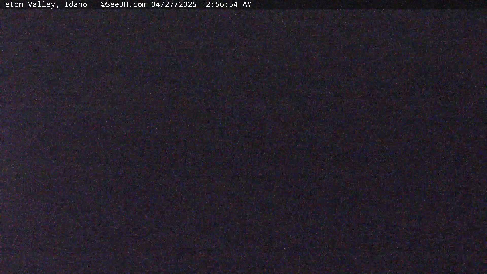 A dark, grainy image shows a night-time scene with no discernible features.