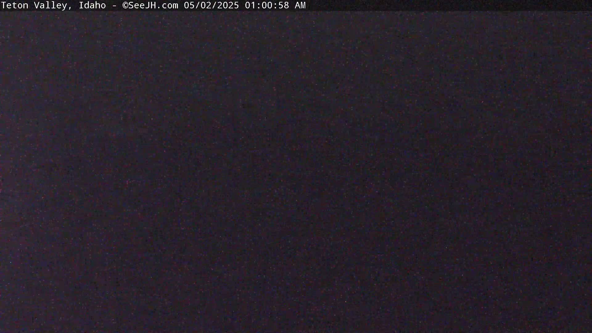 A dark, nighttime image shows a uniformly dark-colored area with very slight variations in tone.