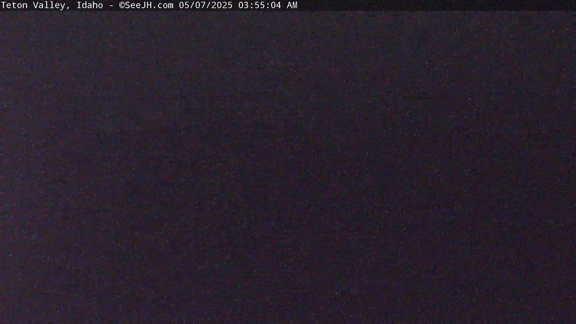 The image shows a dark, possibly nighttime scene with a grainy texture.