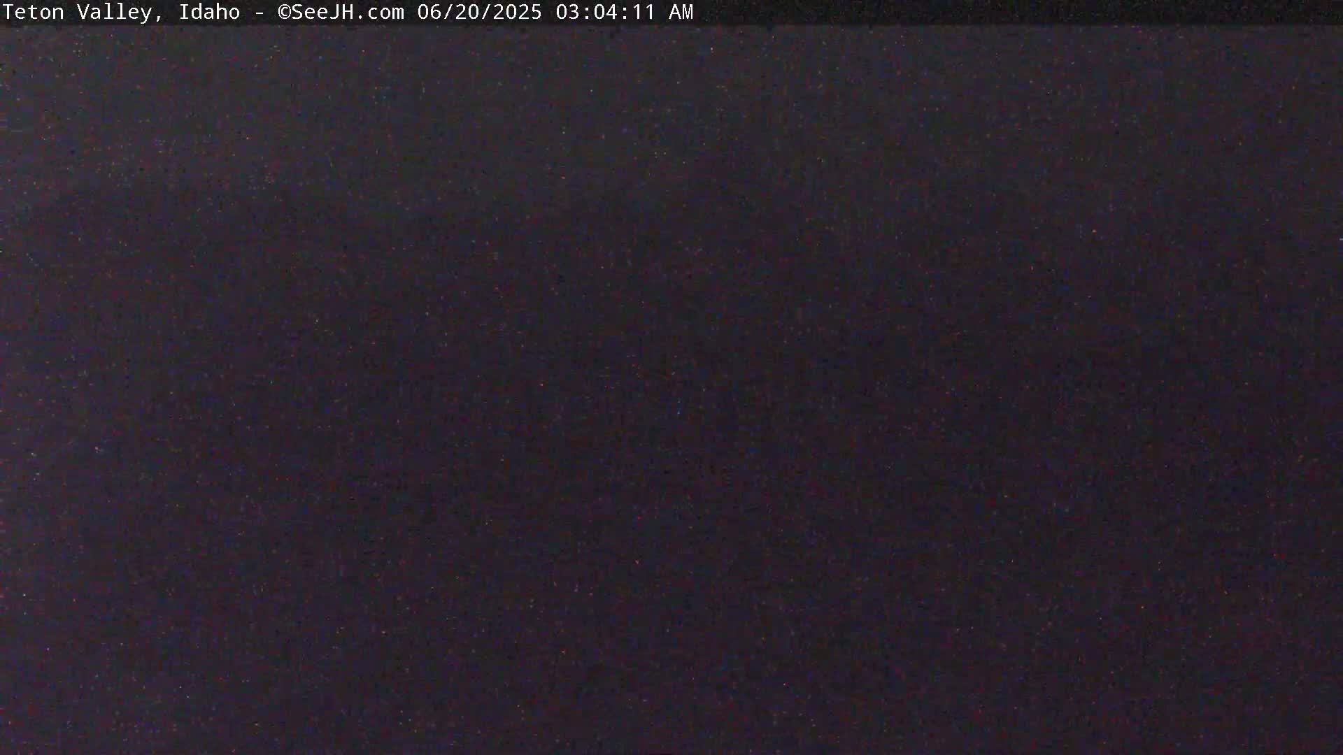 A dark, nighttime image shows a mostly uniform, speckled black surface.