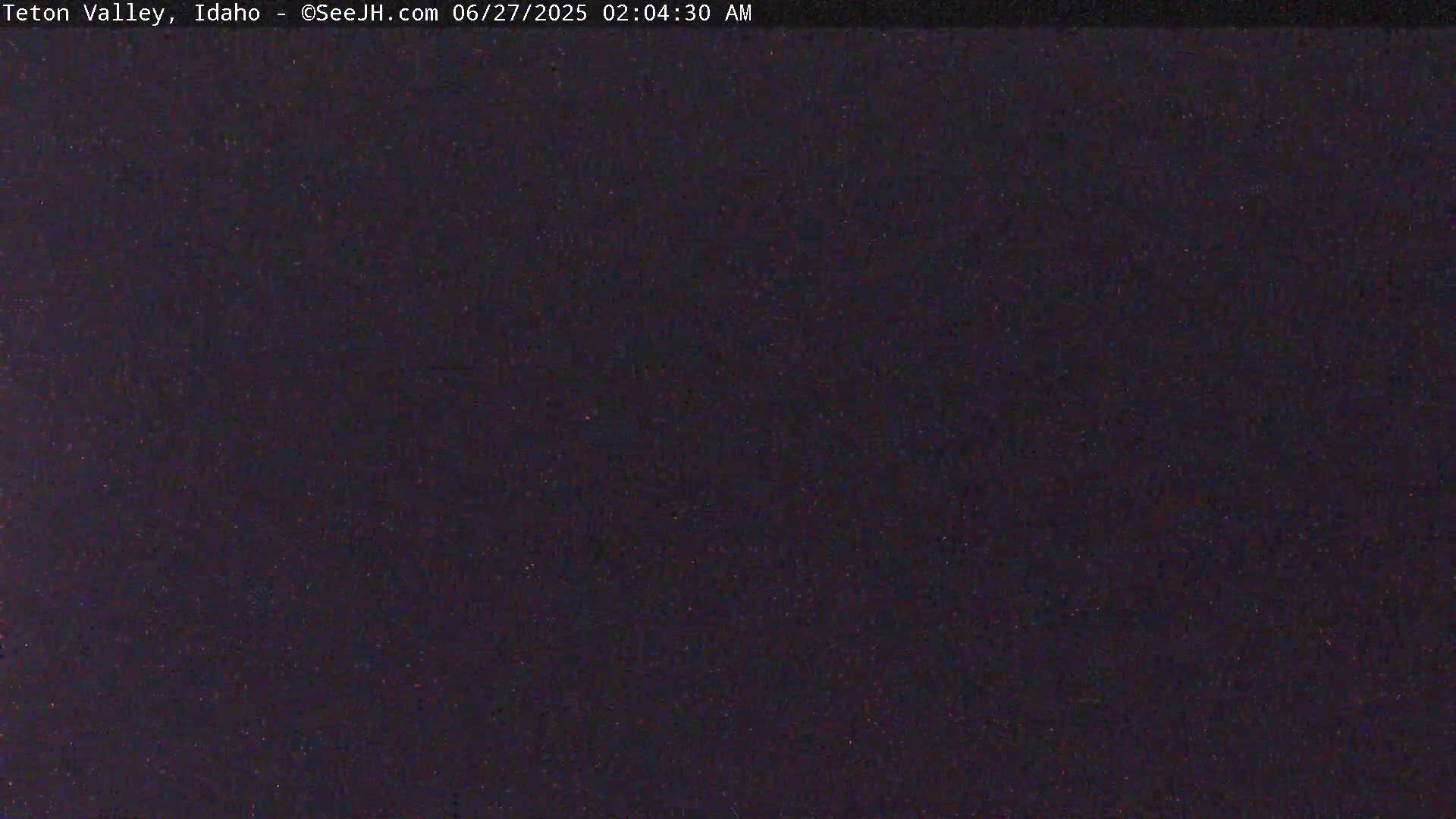 A dark, nighttime image shows a mostly uniform dark-purple sky.