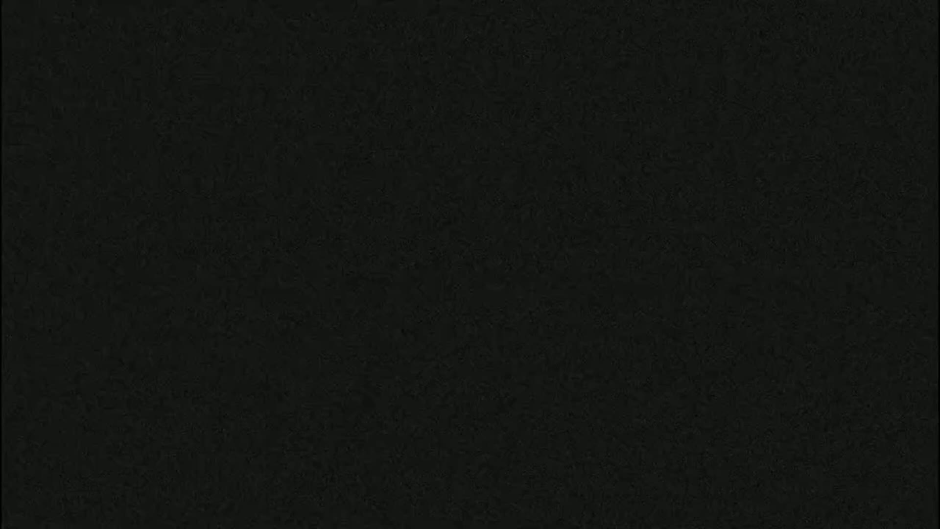 The image is a solid dark gray or black textured background.