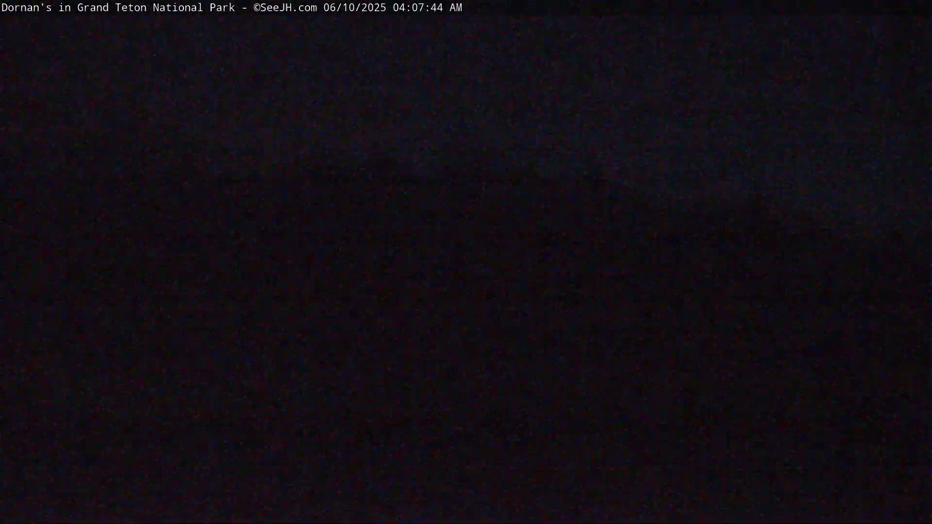A dark, nighttime image shows an indiscernible scene.
