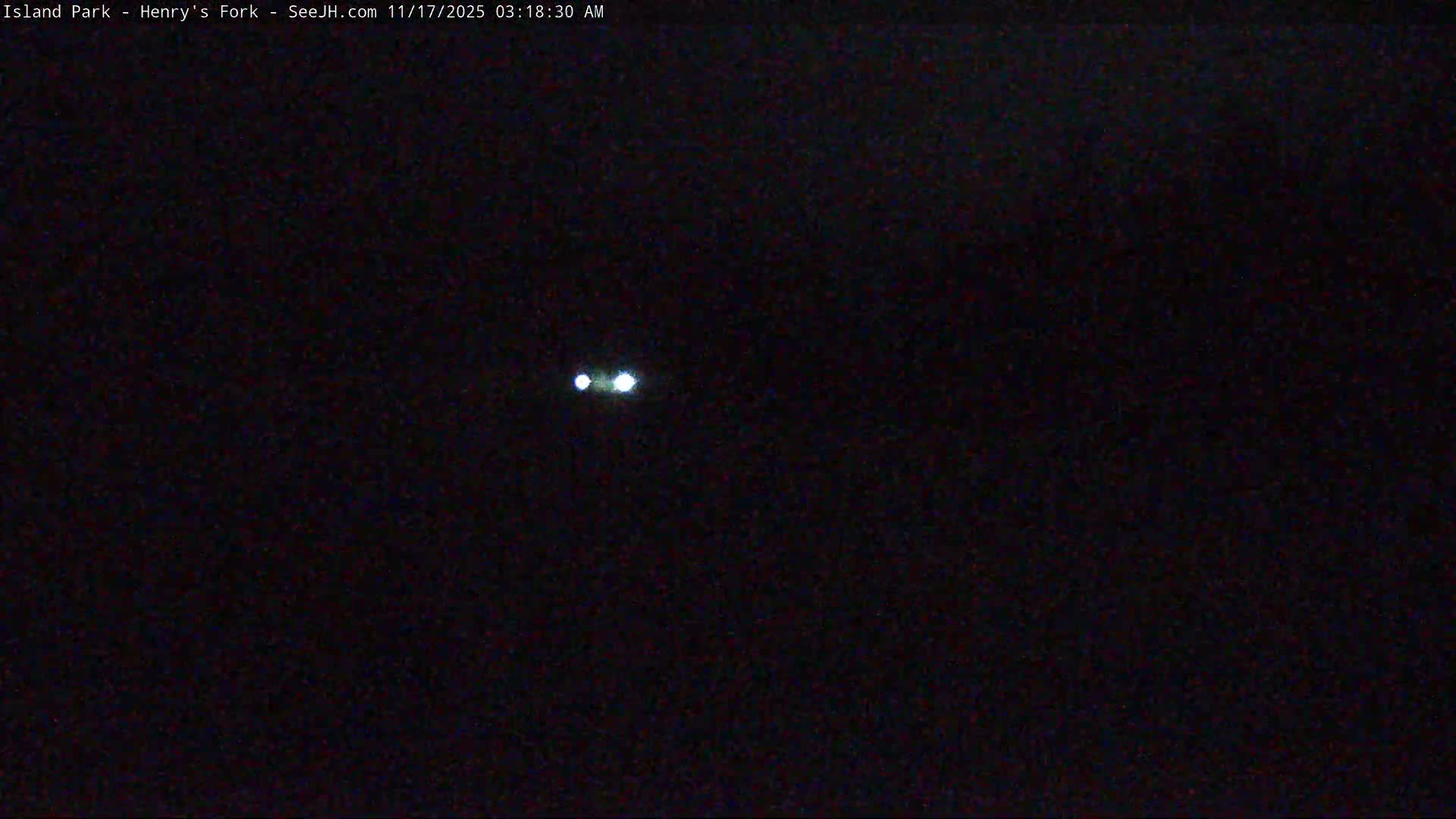 Two distinct bright lights are visible against a completely dark background under clear nighttime conditions.