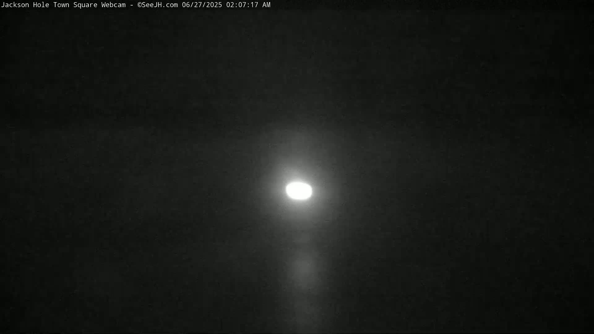 A bright, full moon shines in a dark, night sky.
