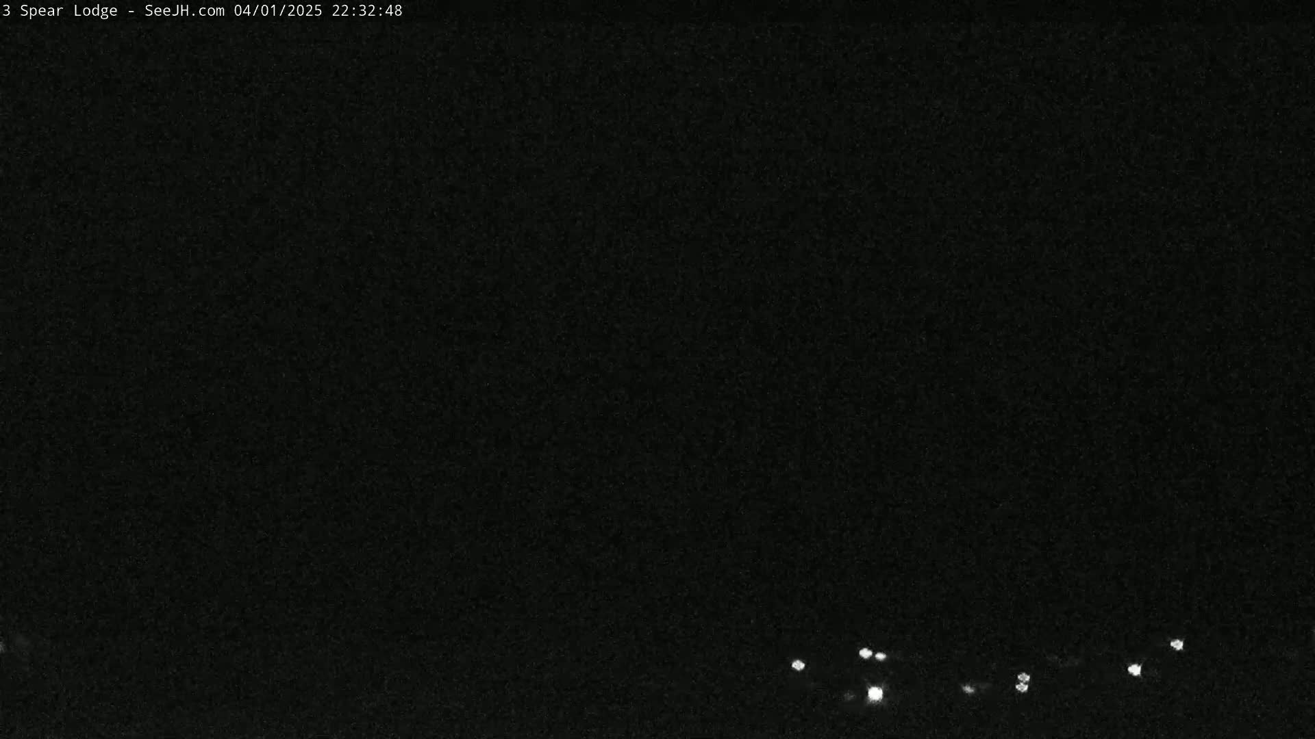 A nighttime long shot shows a dark sky with a few small, distant lights at the bottom.