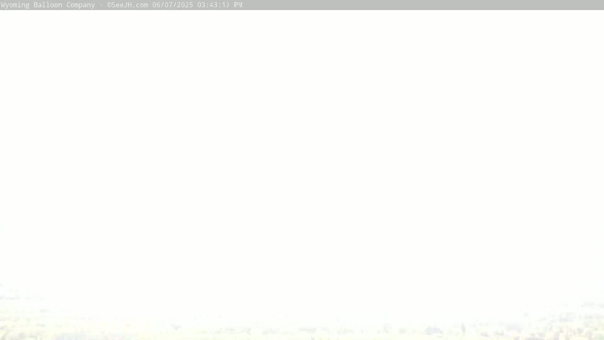 A mostly white, hazy image shows a barely visible landscape at the bottom.