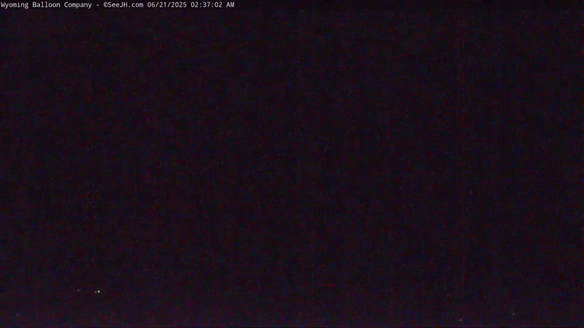A dark, nighttime sky is visible with a few faint lights.