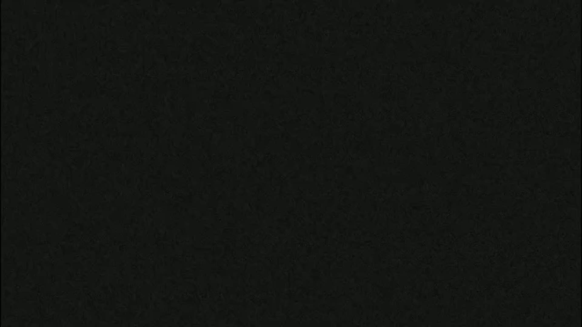 The image is a solid, dark-gray background with a slightly textured surface.