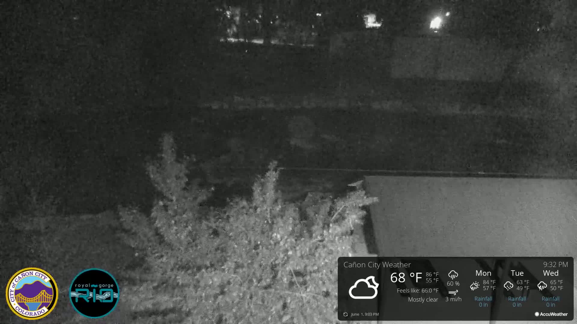 A nighttime, mostly clear view of overgrown vegetation near a flat, dark surface under a 68°F temperature.