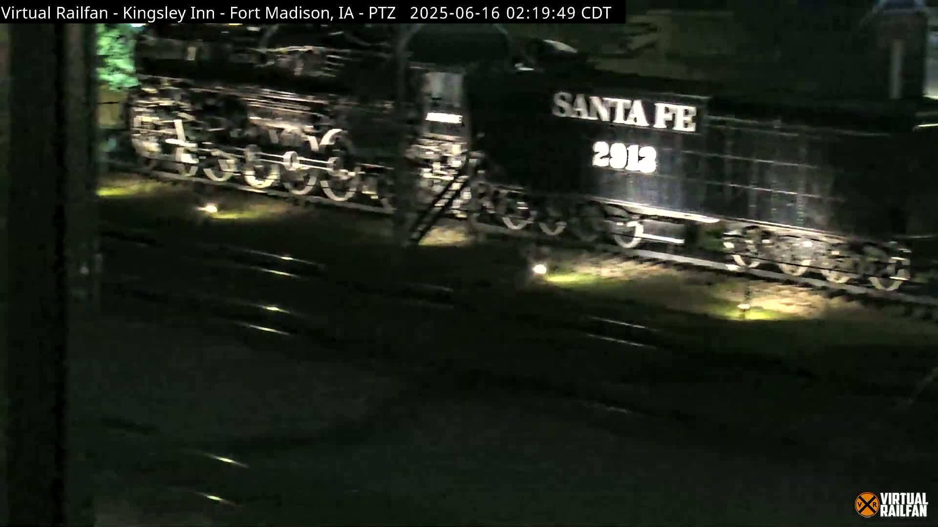 A dark-colored Santa Fe steam locomotive, number 2913, is visible at night.