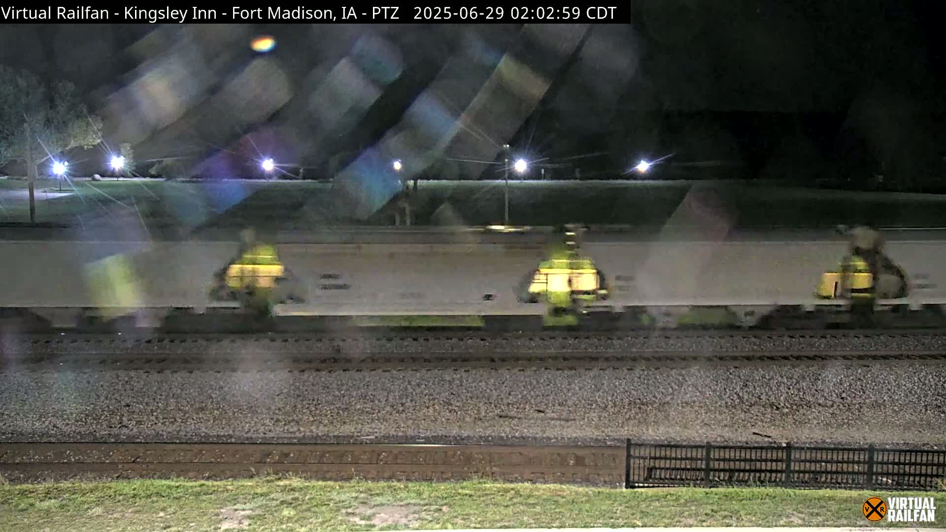 A long freight train passes by at night.