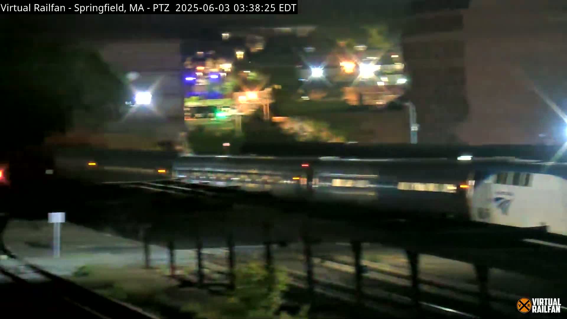 A long passenger train passes by at night.