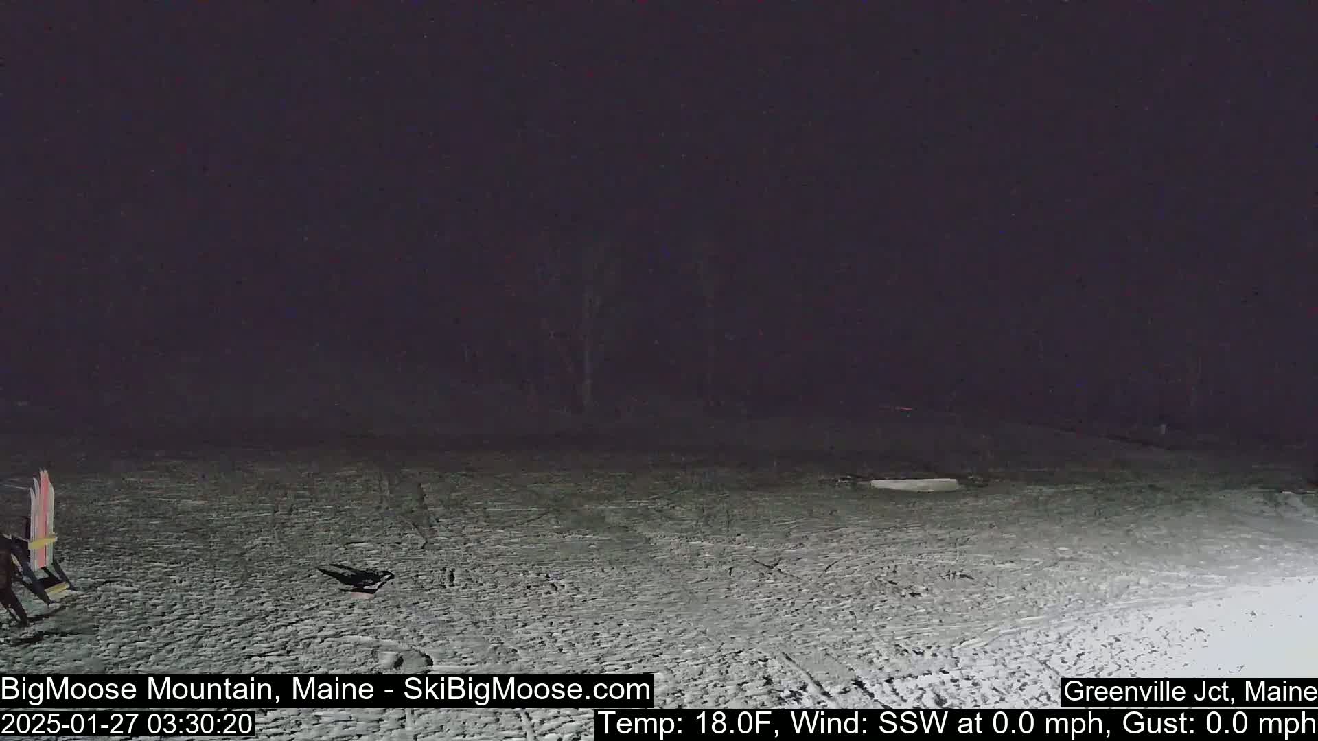 A snow-covered area is visible at night under a dark sky, with a calm wind and a temperature of 18 degrees Fahrenheit.