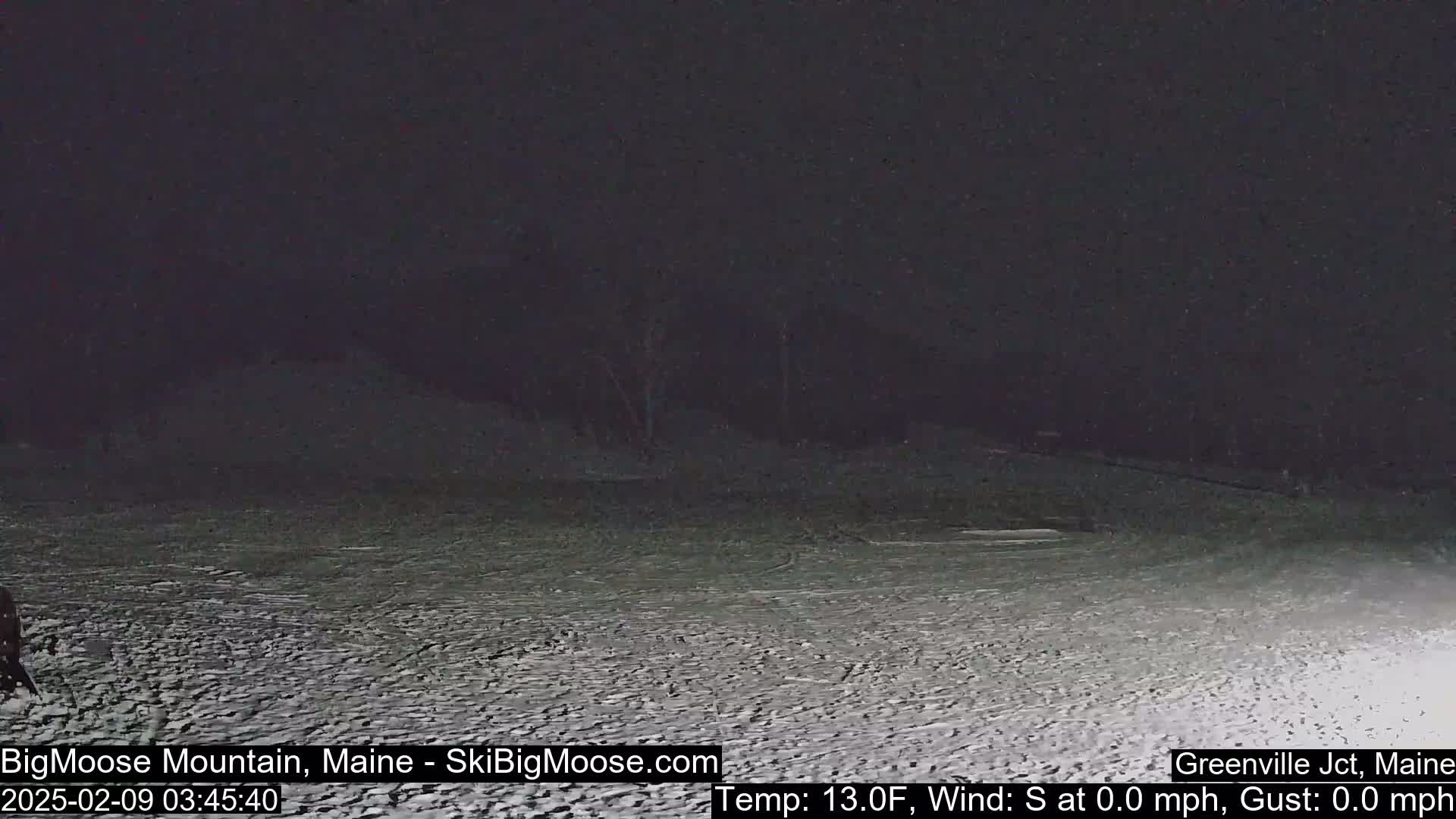 A snow-covered, dark landscape is visible under a nighttime sky with a temperature of 13 degrees Fahrenheit and no wind.