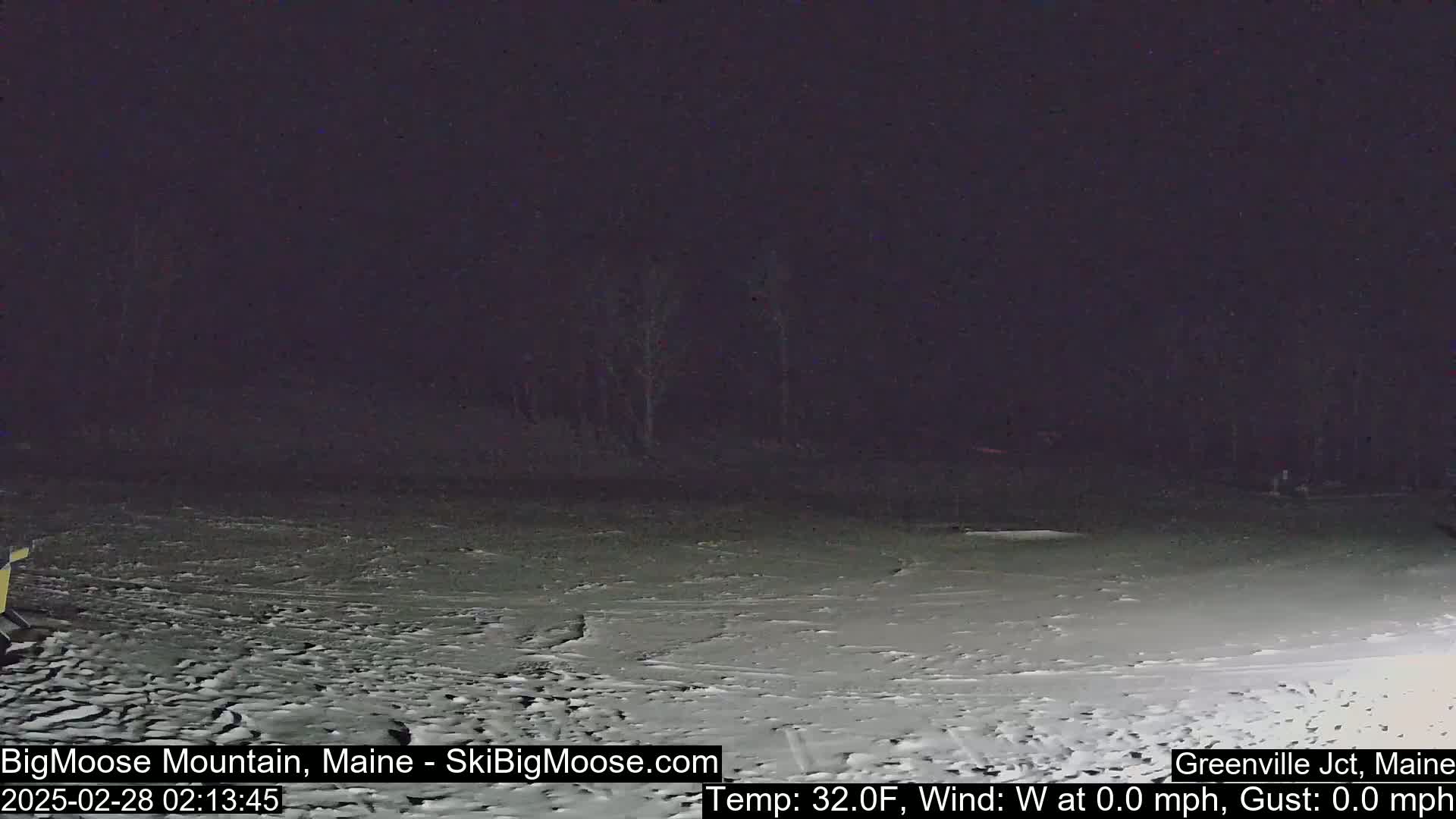 A snow-covered ground is visible under a dark night sky, with a calm wind and a temperature of 32 degrees Fahrenheit.