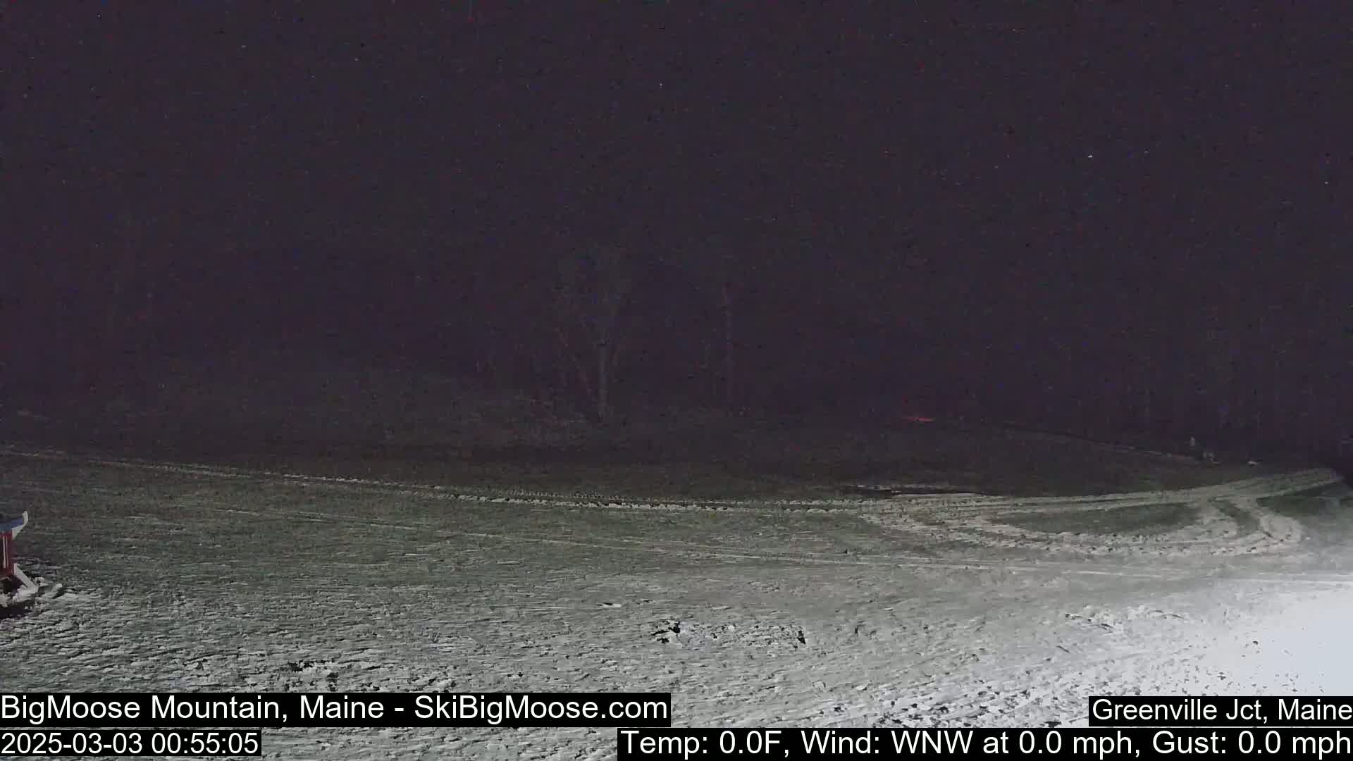A snow-covered landscape is visible at night under a dark sky.