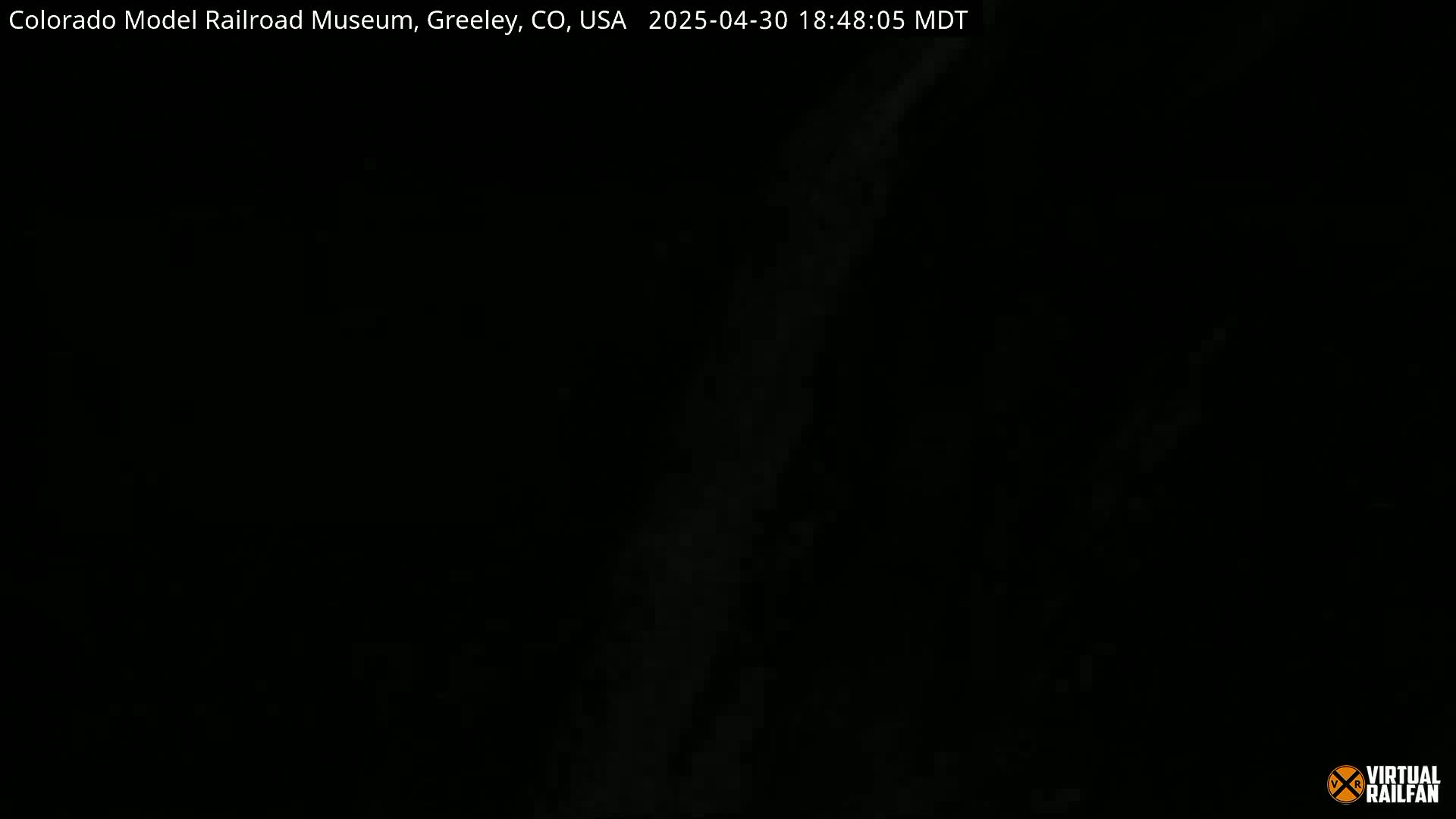 A mostly black image shows a faint, vertical streak of light against a dark background.