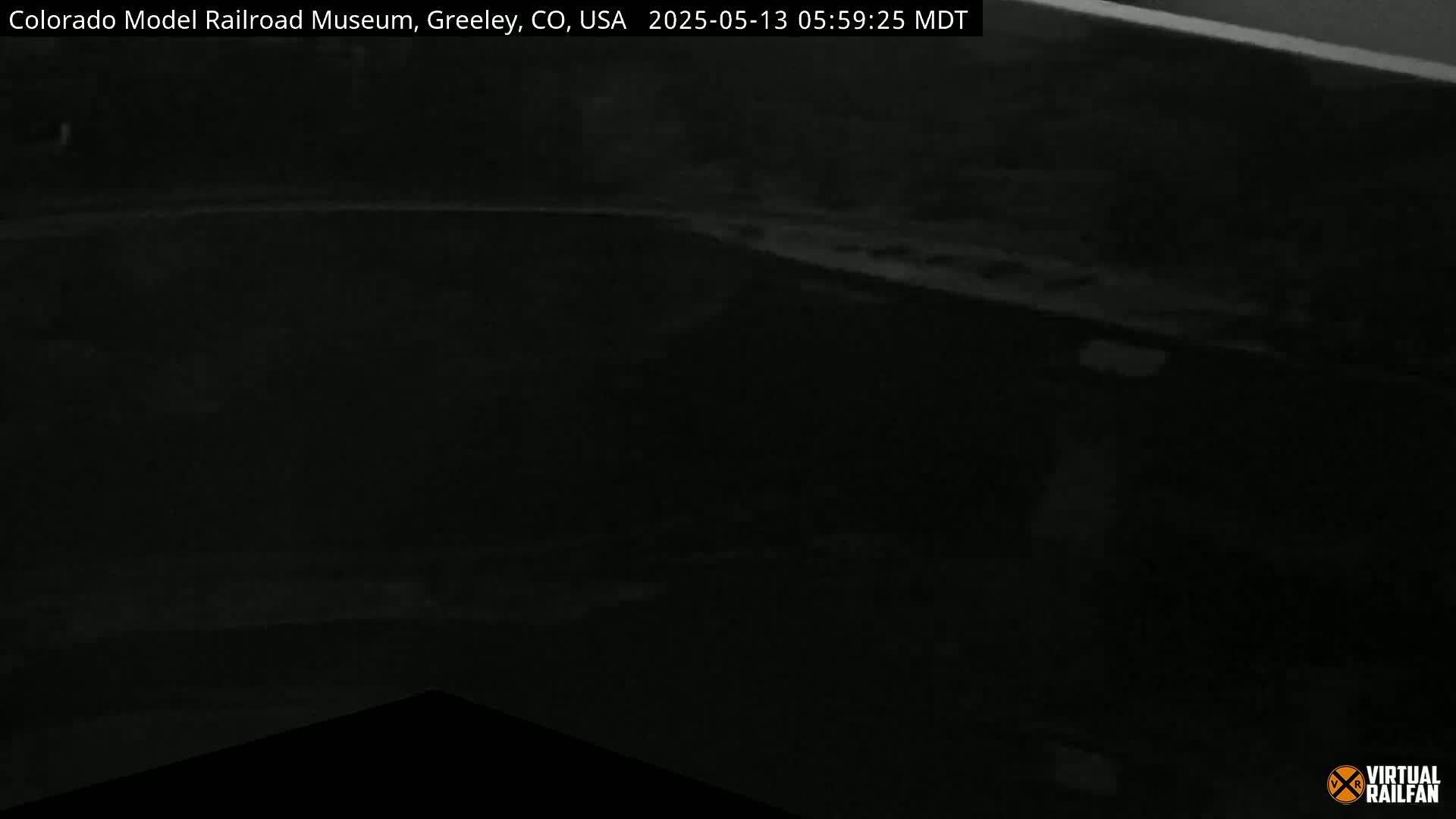 A dark, nighttime image shows a low-light view of what appears to be an indoor space.