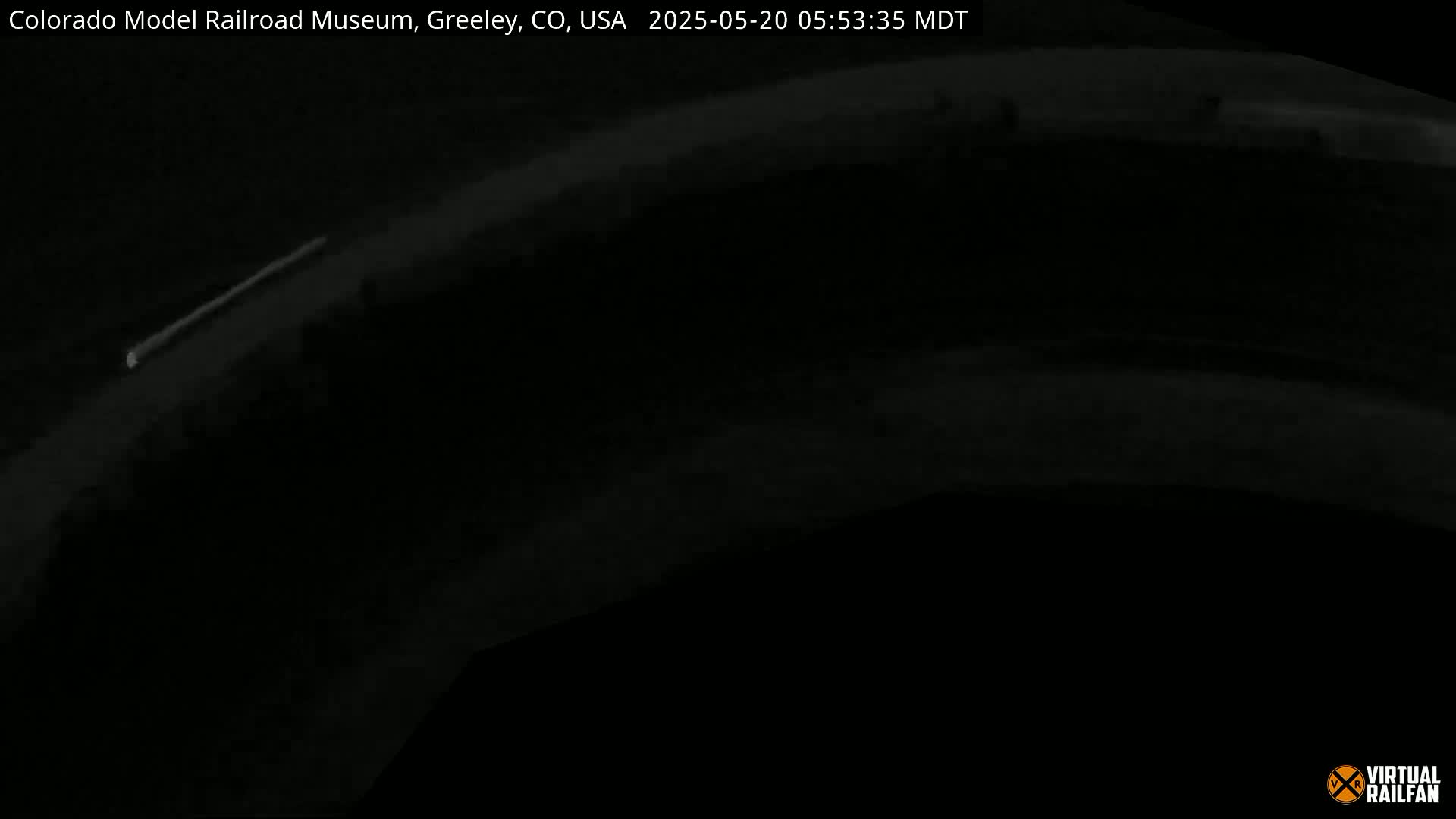 A dark, nighttime image shows a thin, bright line extending across the mostly black frame.