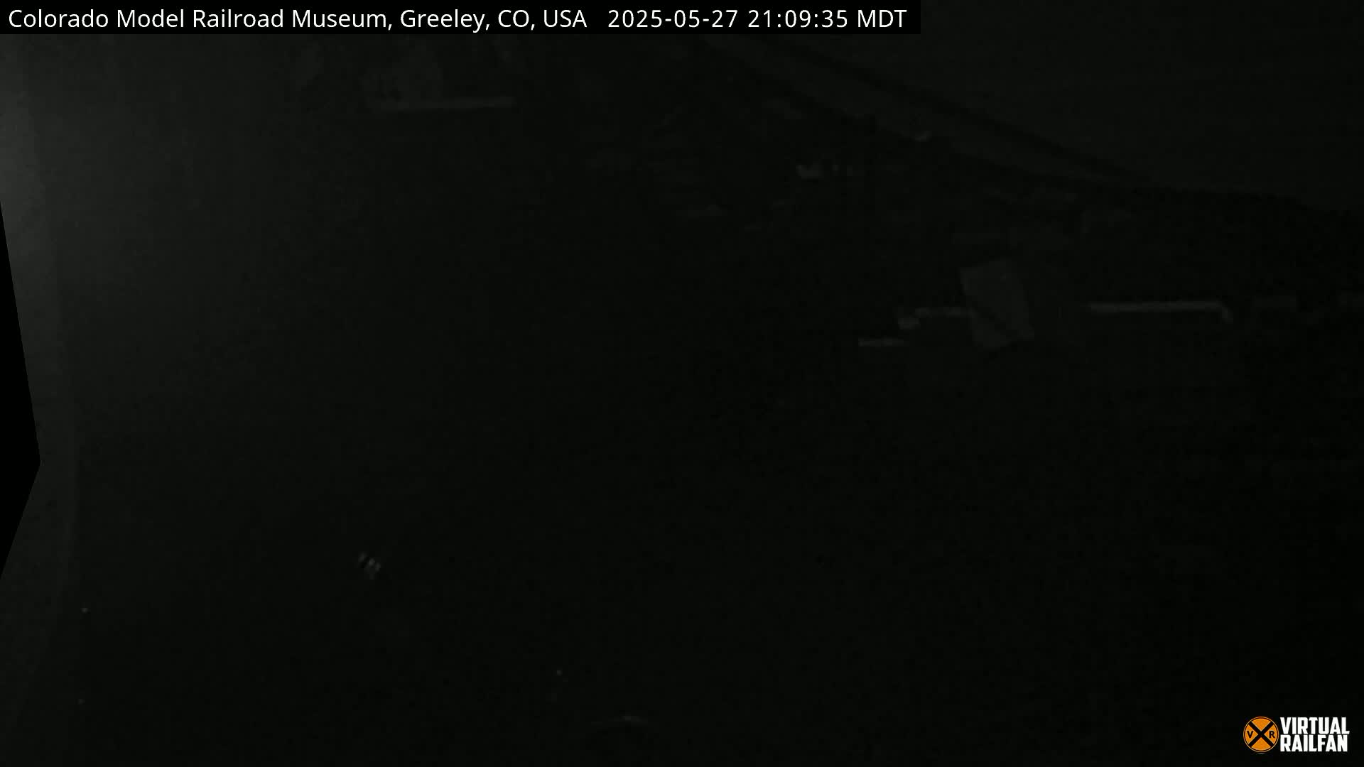A very dark, nighttime image shows an indistinct outdoor scene.